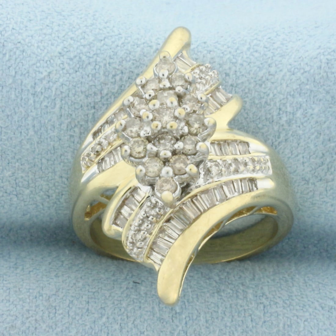 Round and Baguette Diamond Bypass Ring in 10k Yellow Gold: In 10k Yellow Gold. Contains 25 round and 41 baguette, high quality diamonds, SI clarity/I color. 1 1/8 inch wide at widest point. Size 7.25. 7.1g.