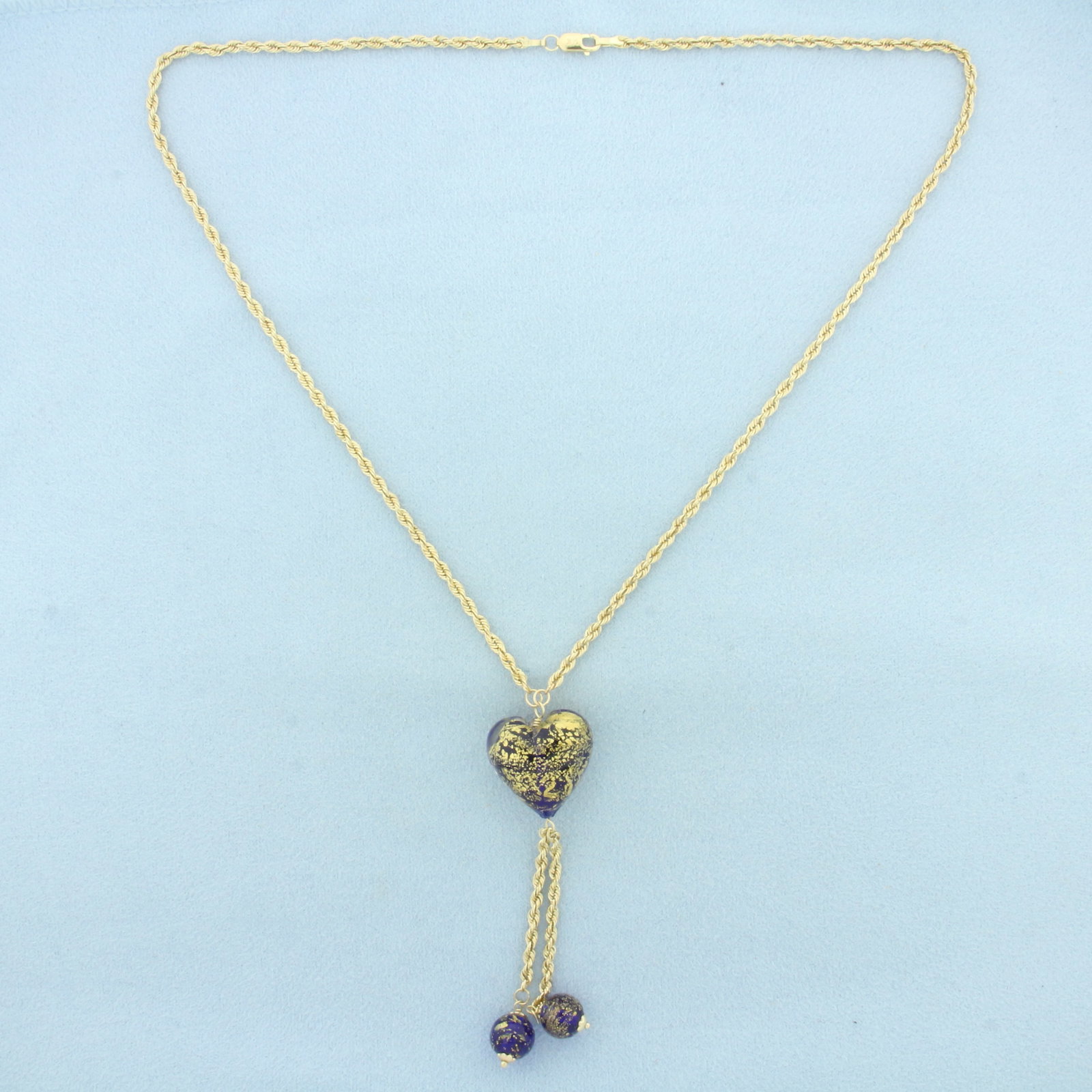 Murano Glass Heart Necklace in 14k Yellow Gold: In 14k Yellow Gold. 20 inches long. 2.1mm wide rope link chain. Heart is 19mm wide. Lobster clasp. 9.5g.