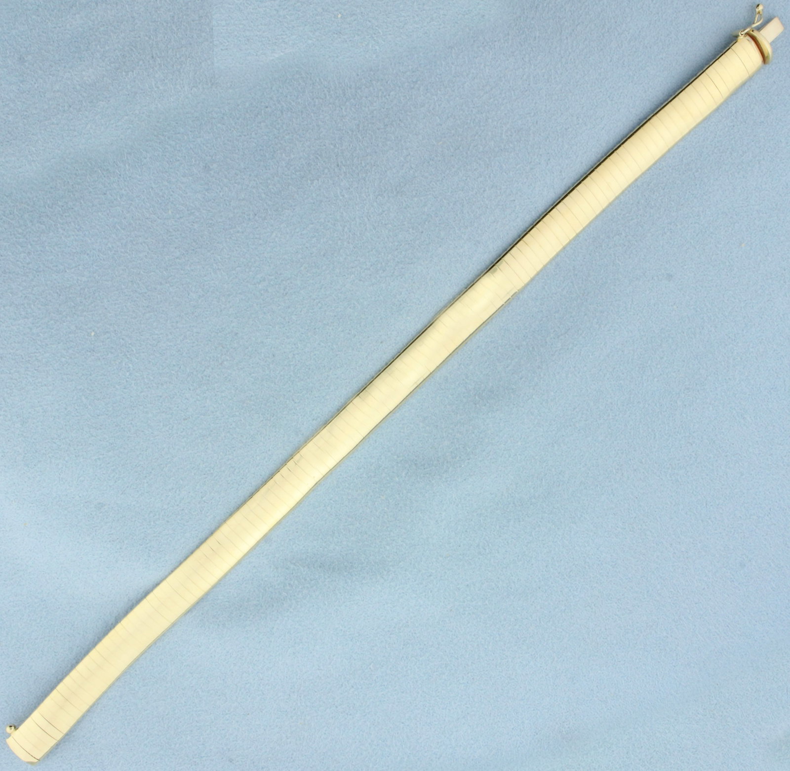 Italian Omega Link Bracelet in 14k Yellow Gold: In 14k yellow gold. Italian made. 8 inches long, 8.1mm wide. Slide clasp with safety latch. 19.6g.