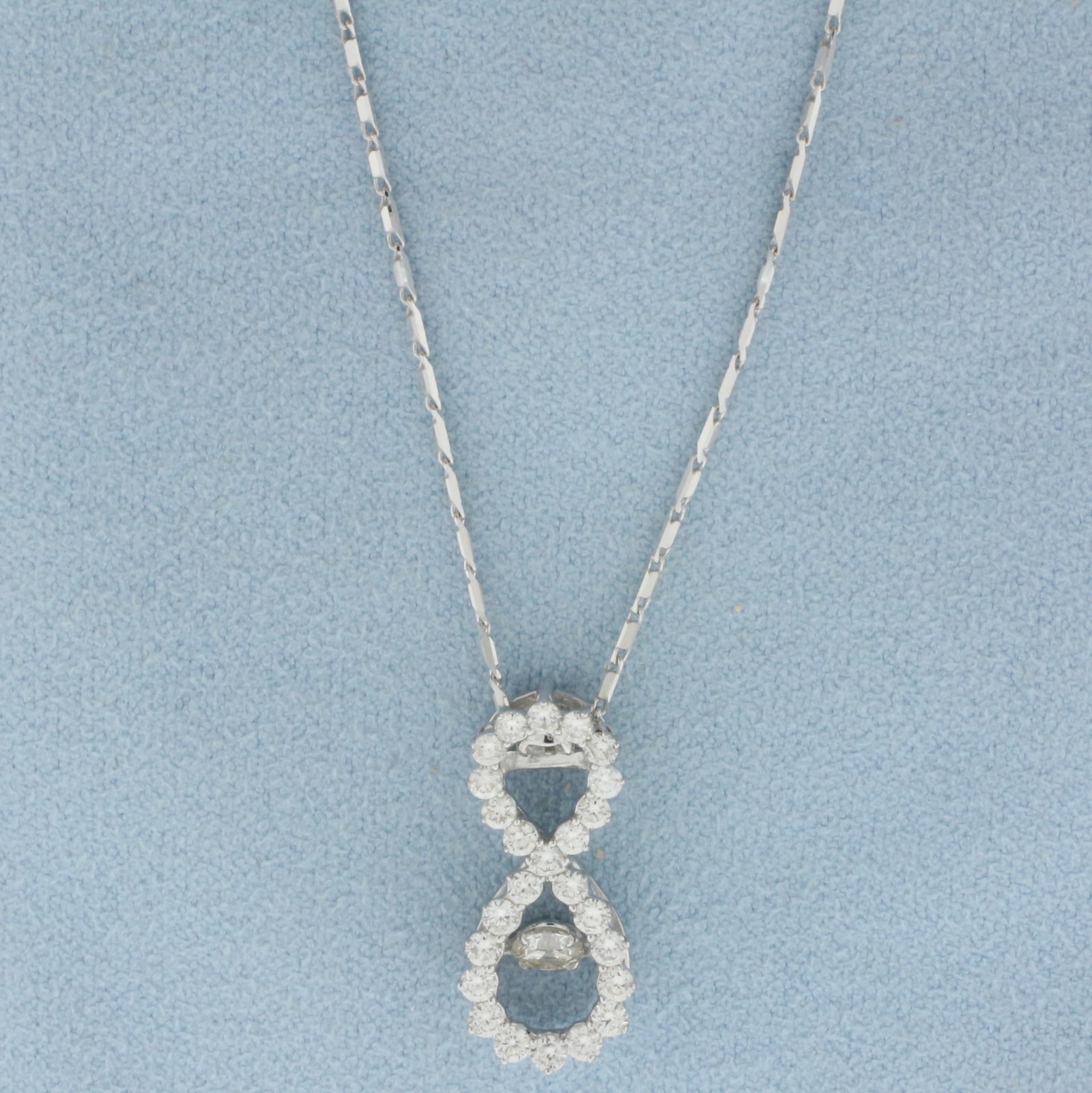 Infinity Design Dancing Diamond Necklace in 14k White Gold: In 14k white gold. Contains one high quality 1/4ct round brilliant diamond, VS1 clarity/G color, set on a suspended head so it "dances" when worn. Also contains 25 diamonds,3/4ct TW, of similar high