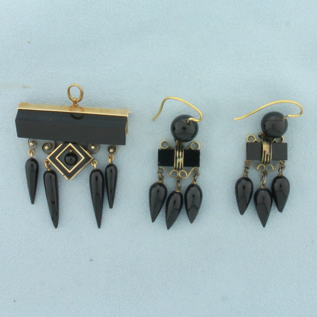 Antique Victorian Black Onyx Earrings and Brooch/Pendant Set in 14k Yellow Gold: In 14k yellow gold. Enamel and wirework details. Brooch pin can convert to pendant. Earring measure 2 inches x 3/4inches. Pendant measures 1 3/4 inches x 1.5 inches. 28.2g.