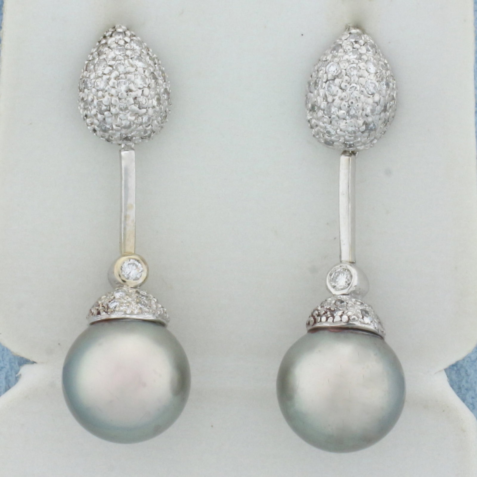 Tahitian Pearl and Pave Diamond Dangle Earrings in 18k White Gold: In 18k white gold. Contains two high quality natural 11mm Tahitian Pearls with high luster and beautiful silver color with peacock iridescent undertone. Also contains ninety-1/2pt and two .04ct high q