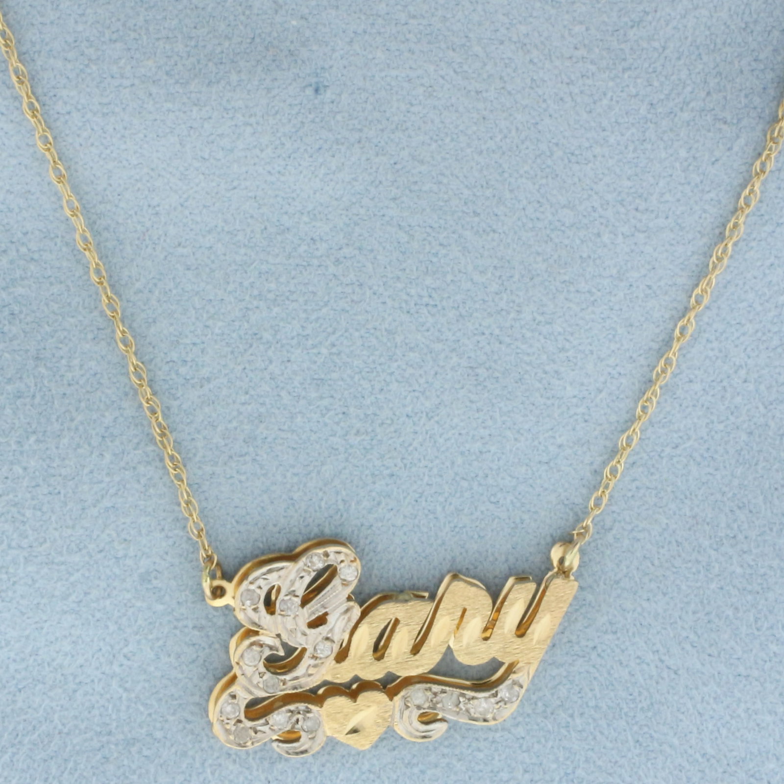 Diamond "Gary" Necklace in 14k Yellow Gold: In 14k yellow gold. Contains fifteen high quality 1/2pt diamonds. 19 inch long and 1.1 inch wide chain, spring clasp. Nameplate is 1 inch by 5/8 inch. 3.9g.