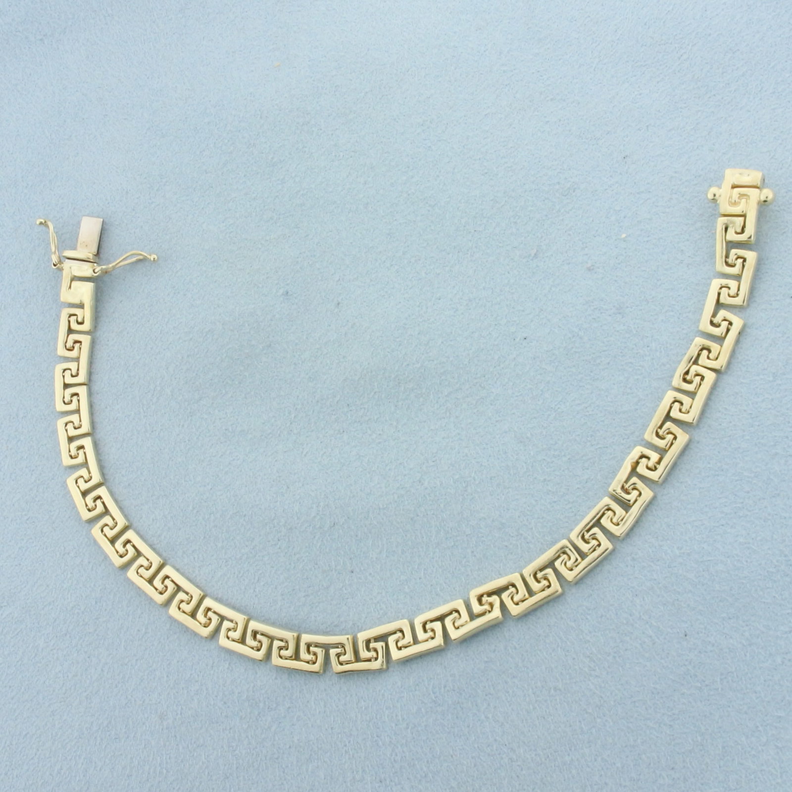 Italian Greek Key Bracelet in 14k Yellow Gold: In 14k Yellow Gold. 7 3/8 inches long. 5.7mm wide. Italian made. Concealed slide closure with safety latch. 10.5g.
