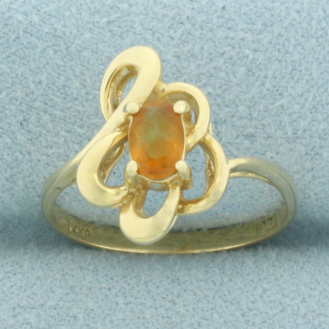 Citrine Abstract Design Ring in 14k Yellow Gold: In 14k Yellow Gold. Contains one 5.7mm high quality oval cut natural Citrine gemstone with intense color and excellent clarity. 14.7mm wide at top. Size 7.5. 2.6g.