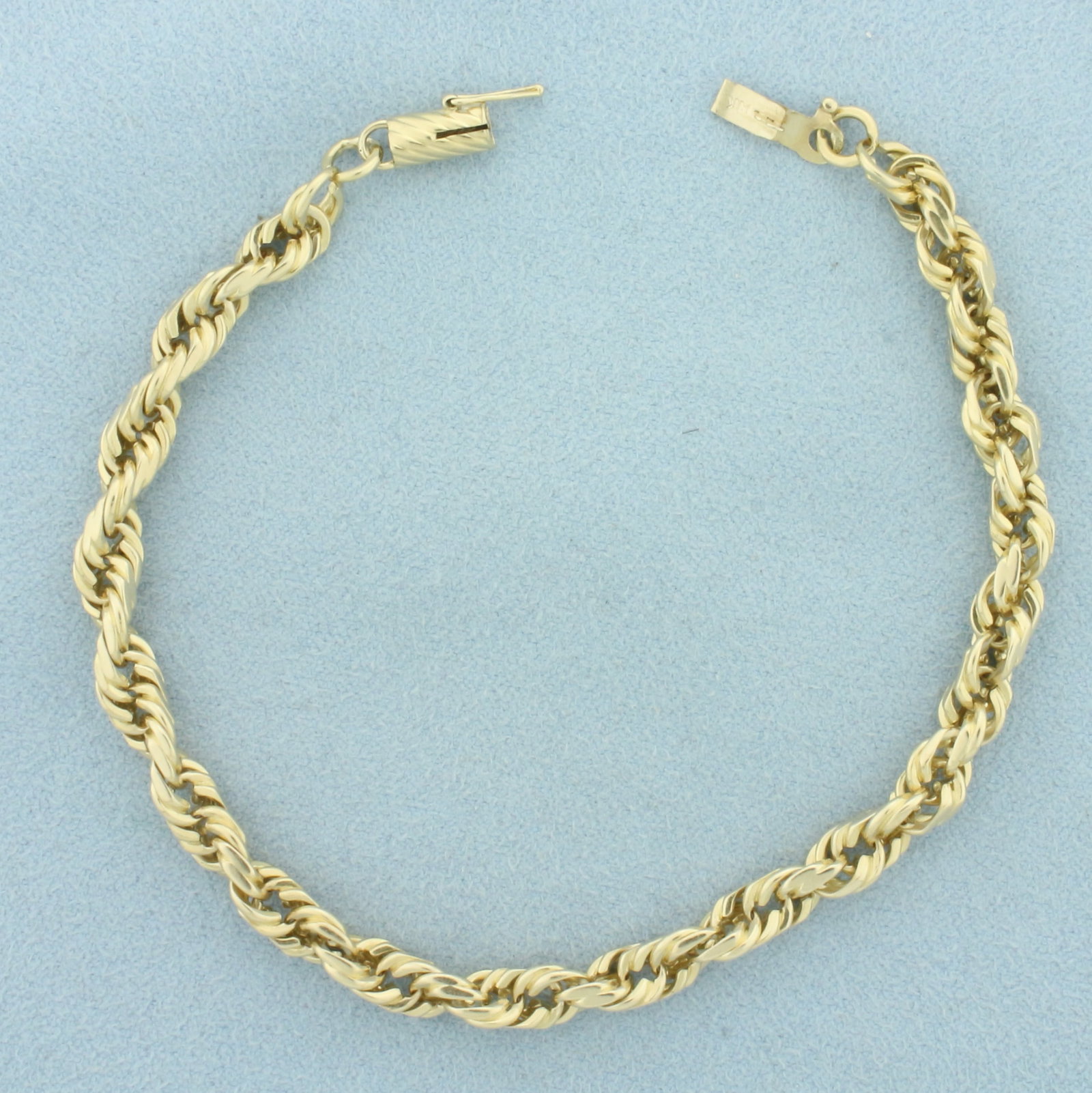 Rope Link Bracelet in 14k Yellow Gold: In 14k Yellow Gold. 8 inches long. 5mm wide. Barrel clasp with safety latch. 15.6g.