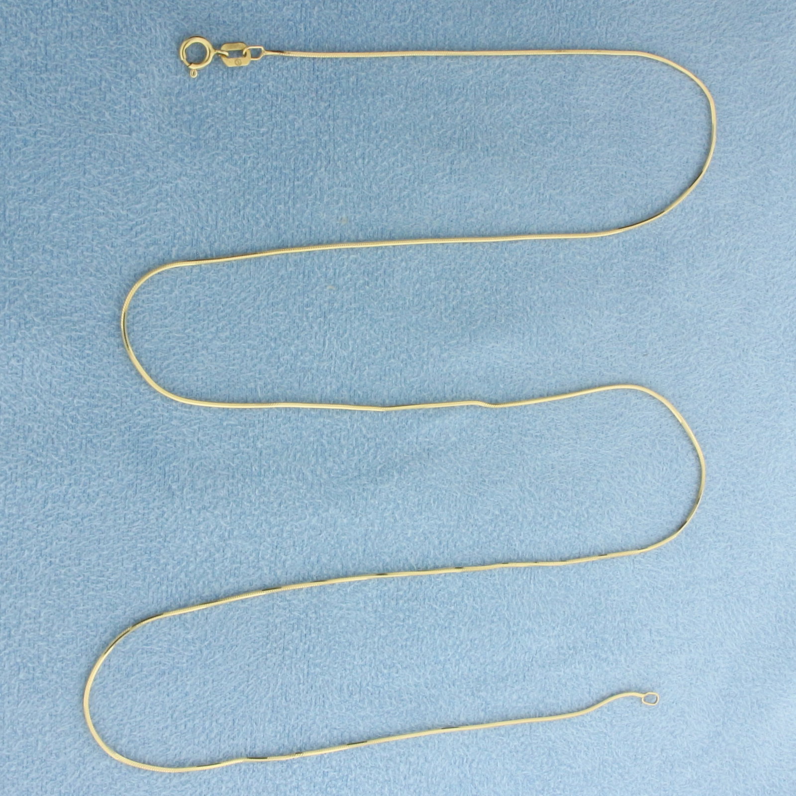 Italian 20 Inch Snake Link Chain Necklace in 14k Yellow Gold: In 14k Yellow Gold. 20 inches long. 0.7mm wide. Made in Italy. Spring clasp. 2.3g.