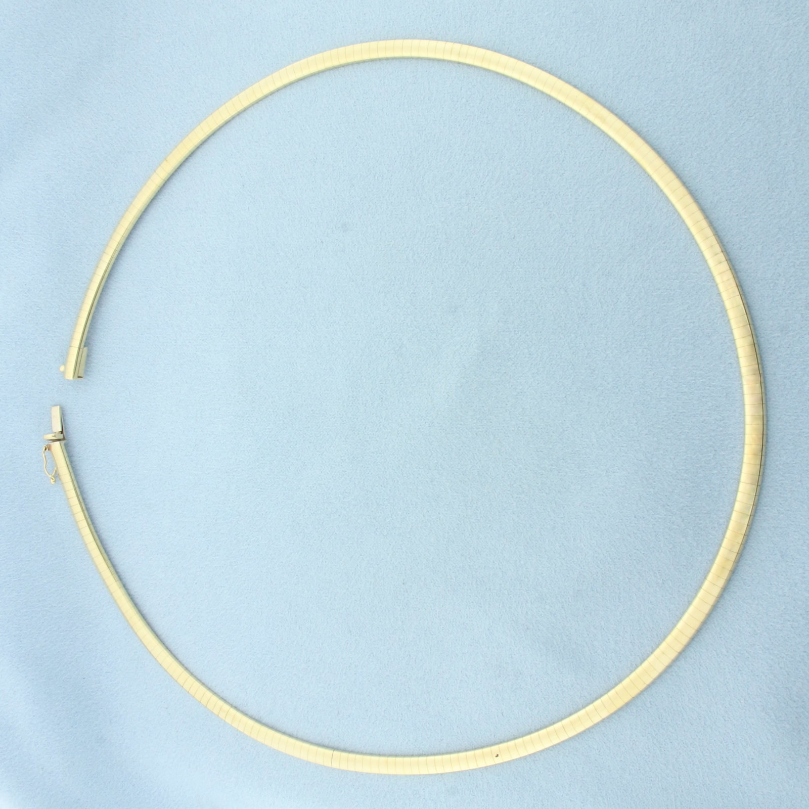 18 Inch Italian Omega Necklace in 14k Yellow Gold: In 14k Yellow Gold. 18 inches long. 4.2mm wide. Italian made. Concealed slide clasp with safety latch. 29.0g.