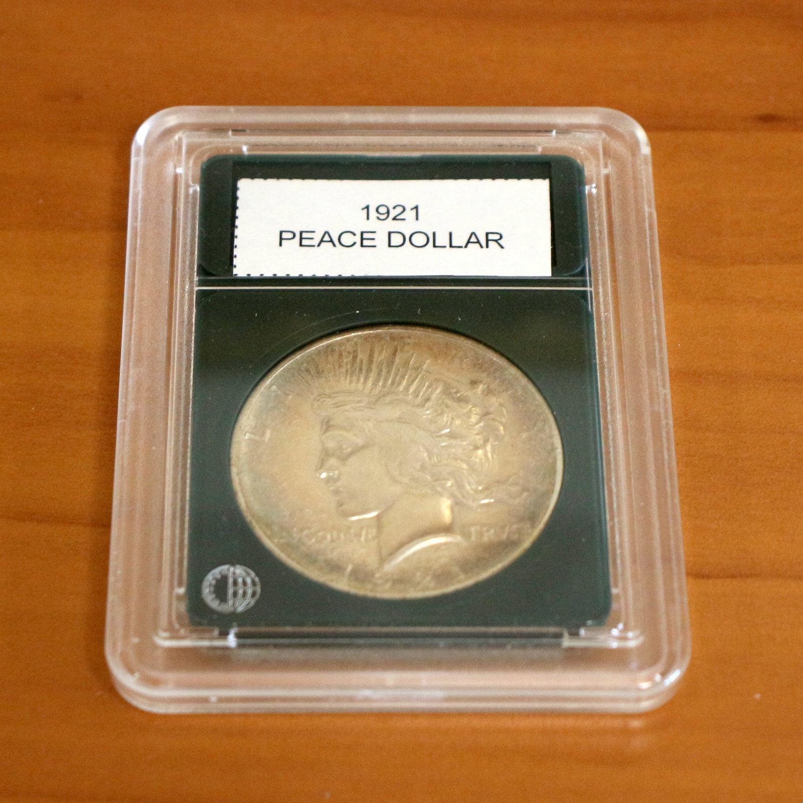 1921 Peace Silver Dollar In Slab: Contains one 1921 Peace Dollar. Packaged by CoinWorld.