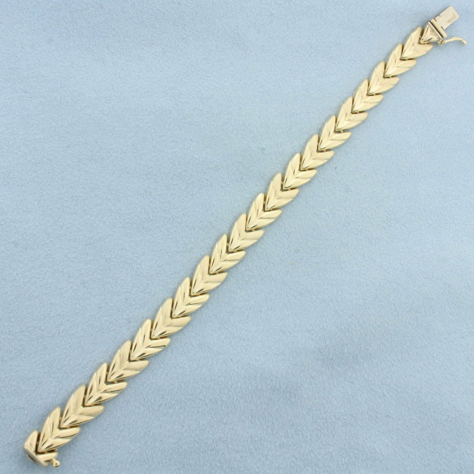 Satin and High Polish Finish Chevron Design Bracelet in 14k Yellow Gold: In 14k Yellow Gold. 6 5/8 inches long. 8.6mm wide. Concealed slide clasp with safety latch. 11.6g.