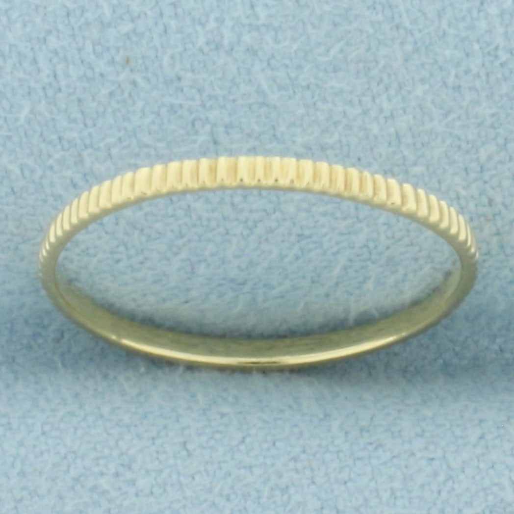 Thin Fluted Desing Band Ring in 14k Yellow Gold: In 14k Yellow Gold. 1.4mm wide. Size 6.5. .6g.