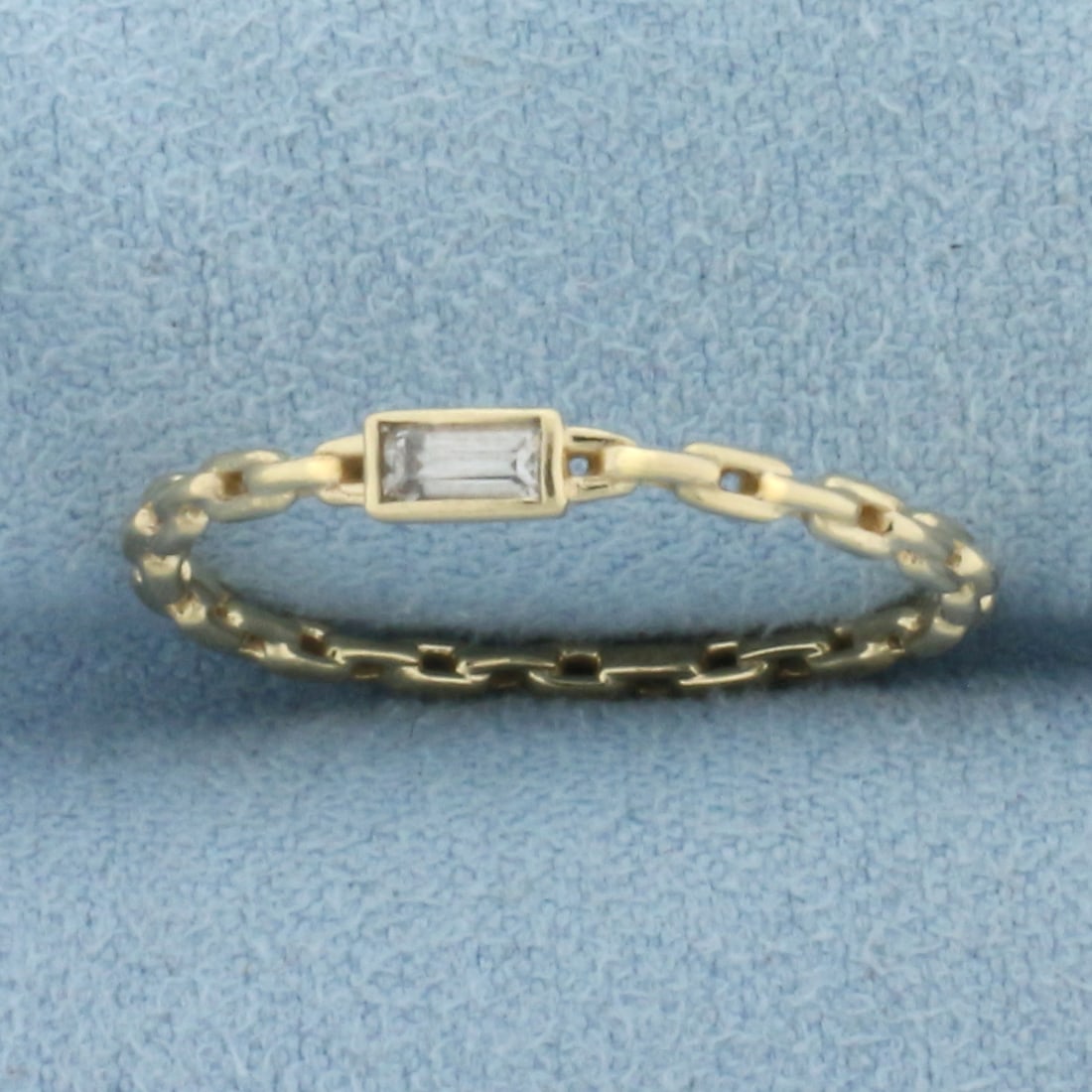 White Sapphire Chain Link Ring in 14k Yellow Gold: In 14k Yellow Gold. Contains one 4x2mm high quality White Sapphire gemstone with excellent clarity. 2.6mm wide at widest part of ring. Size 7. 1.1g.