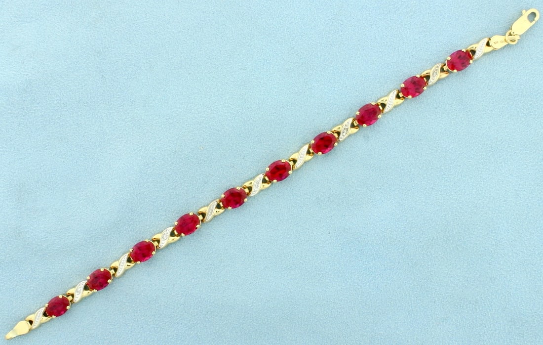 Ruby and Diamond Tennis Bracelet in 10k Yellow Gold: In 10k yellow gold. Contains ten Lab 8mmx6mm Ruby gemstones, 15ct TW, with vibrant ruby red color and excellent clarity. Also contains five high quality .01ct diamonds. 7 3/4" long with lobster clasp.