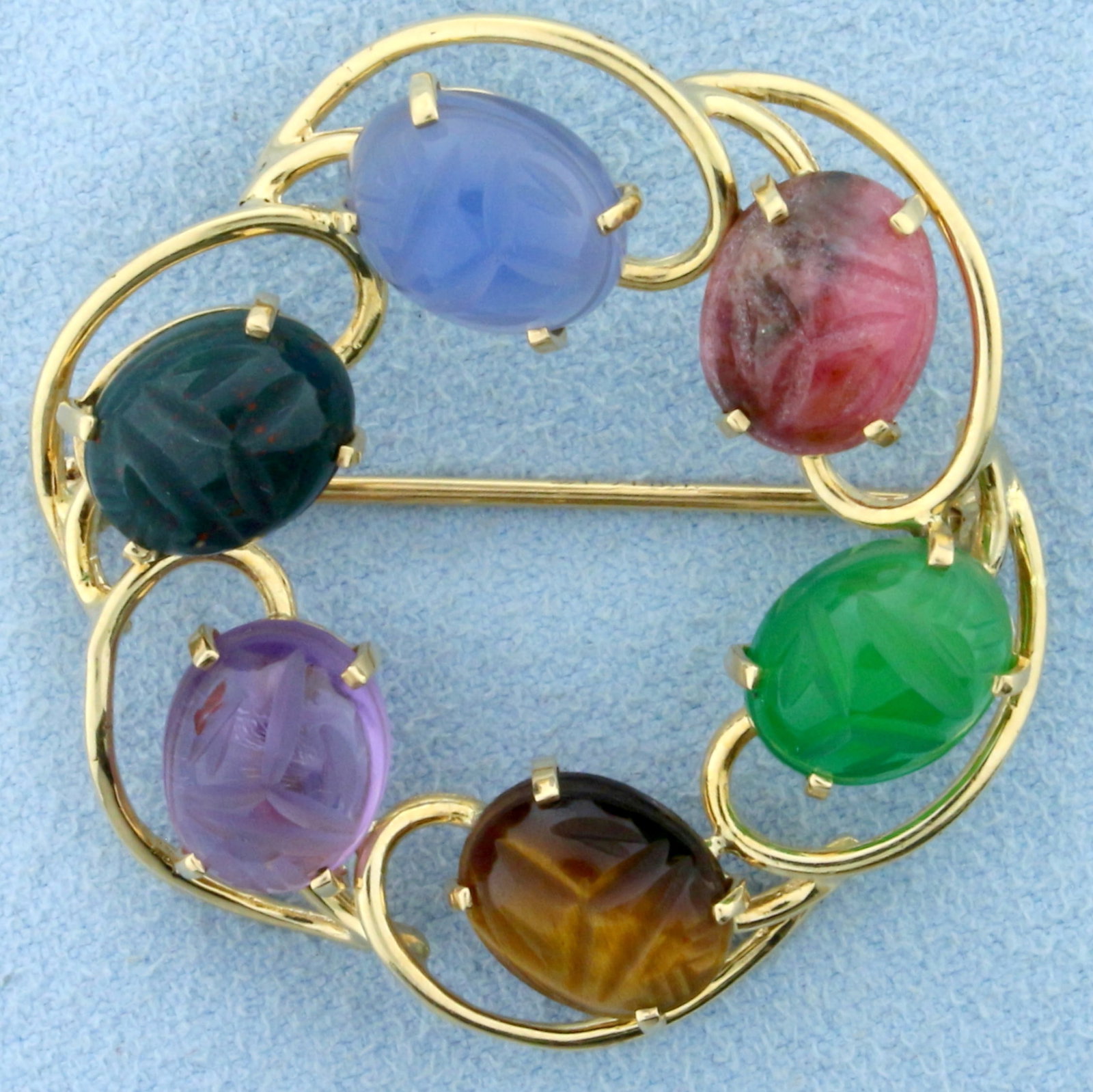 Vintage Hand Carved Scarab Pin Brooch in 14K Yellow Gold: In 14K Yellow Gold. Contains six high quality 10 x 8mm cabochon gemstones with carvings on each side including amethyst, quartz, topaz, jade, cats eye, and tourmaline. 1 1/4 inches long, 1 1/4 inches