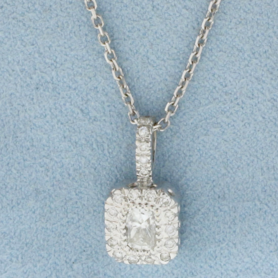 Radiant Diamond Necklace in 14K White Gold: In 14K White Gold. Contains one high quality .55ct radiant cut Diamond, VS clarity/H color. Also contains twenty .01ct round Diamonds of similar high quality. Pendant is 3/4 inch long. Chain is 18 inc