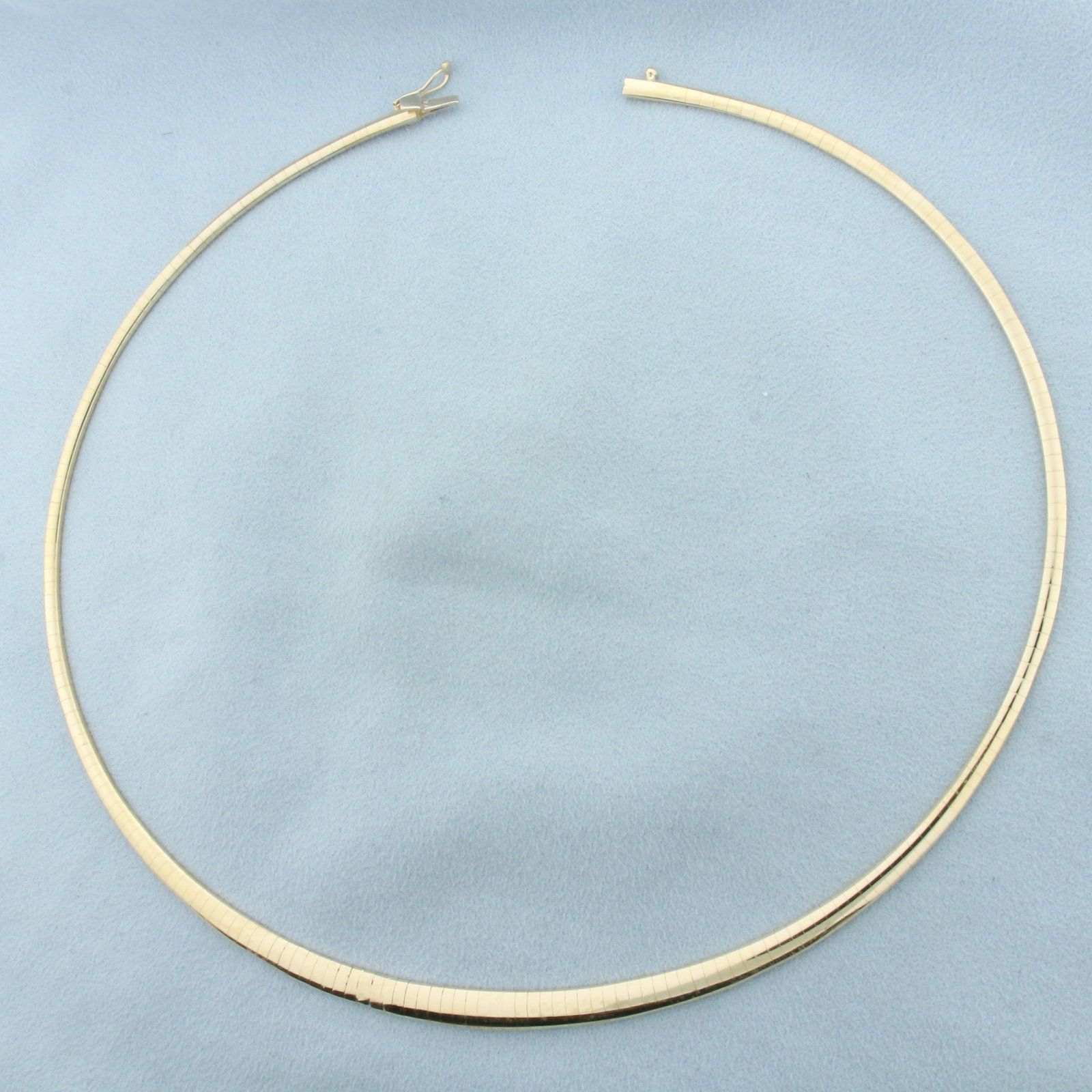 17 Inch Graduated Omega Link Necklace in 14k Yellow Gold: In 14k Yellow Gold. 17 inches long. 3 to 6mm wide. Slide closure with safety latch. 22.9g.