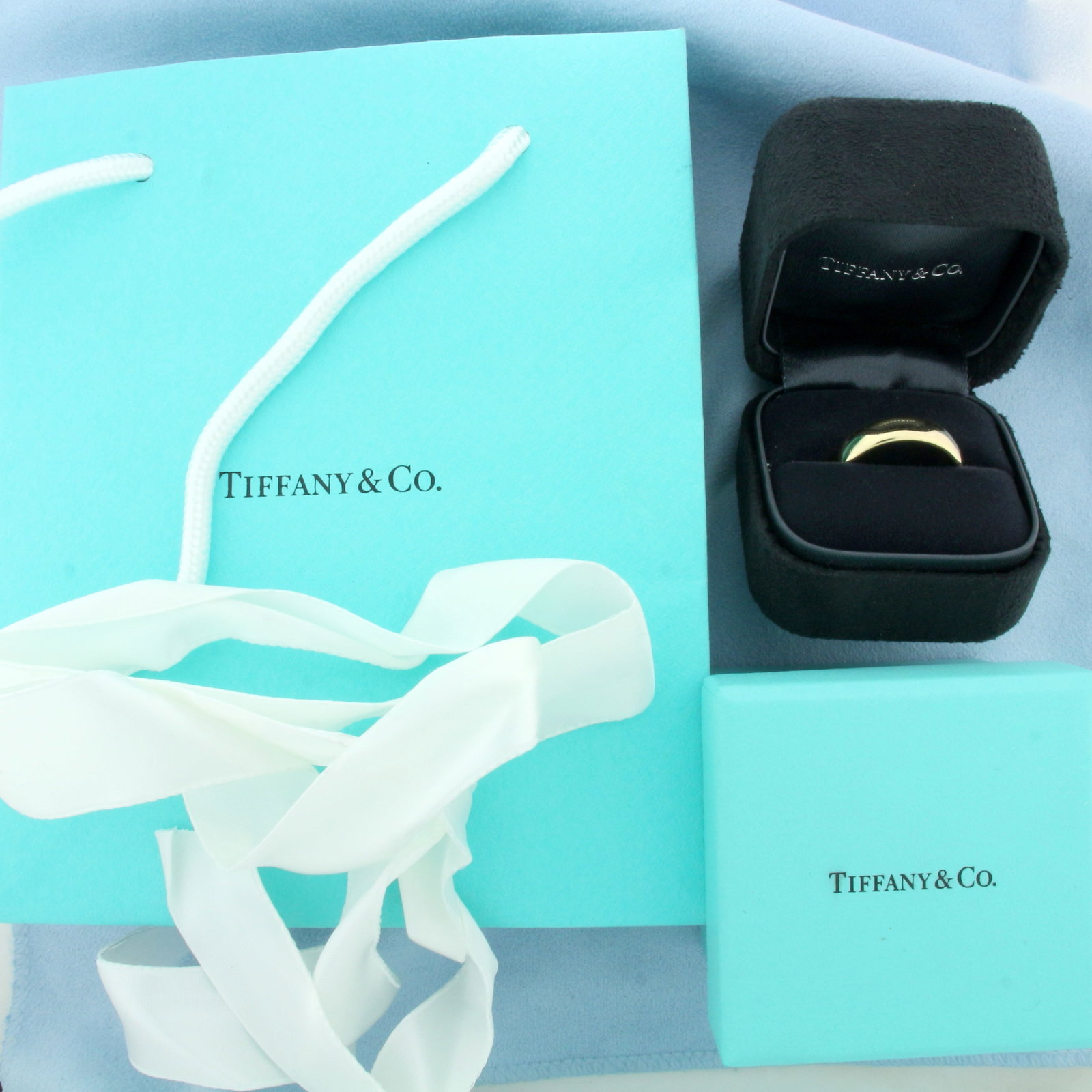 Tiffany and Co. Mens Forever Wedding Band Ring in 18k Yellow Gold: In 18k Yellow Gold. Guaranteed authentic. 5.75mm wide. Comes with box, bag, and ribbon. Size 10.25. 9.2g.