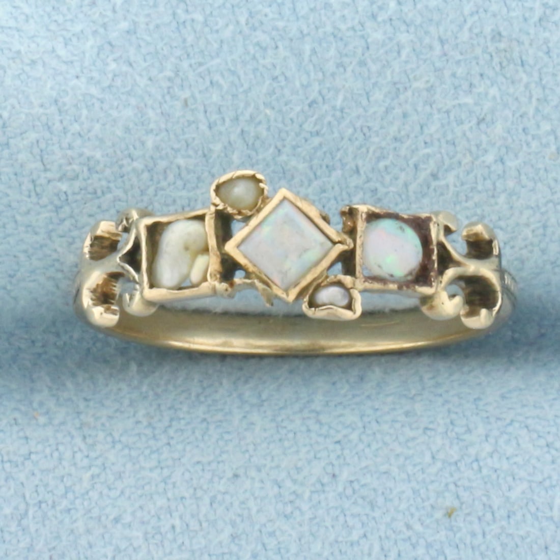 Antique Opal and Freshwater Pearl Ring in 10k Yellow Gold: In 10k Yellow Gold. Contains two high quality natural Opal gemstones with excellent play of color and one freshwater pearl. 6mm wide at widest spread. Size 7. 1.5g.