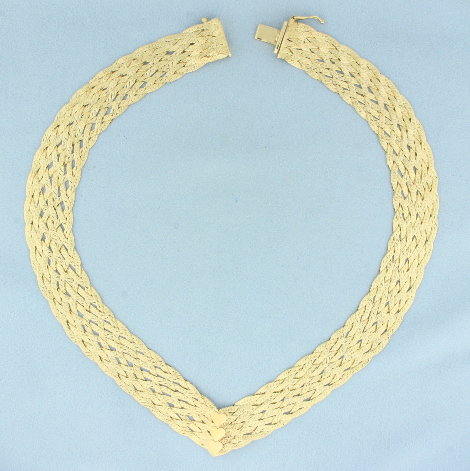 Italian Woven V-Neck Heart Necklace in 14k Yellow Gold: In 14k yellow gold. Italian made. 16 inches long and 5/8 inch wide. Unique diamond cut finish for extra sparkle. Slide clasp with safety latch. 32.5g.