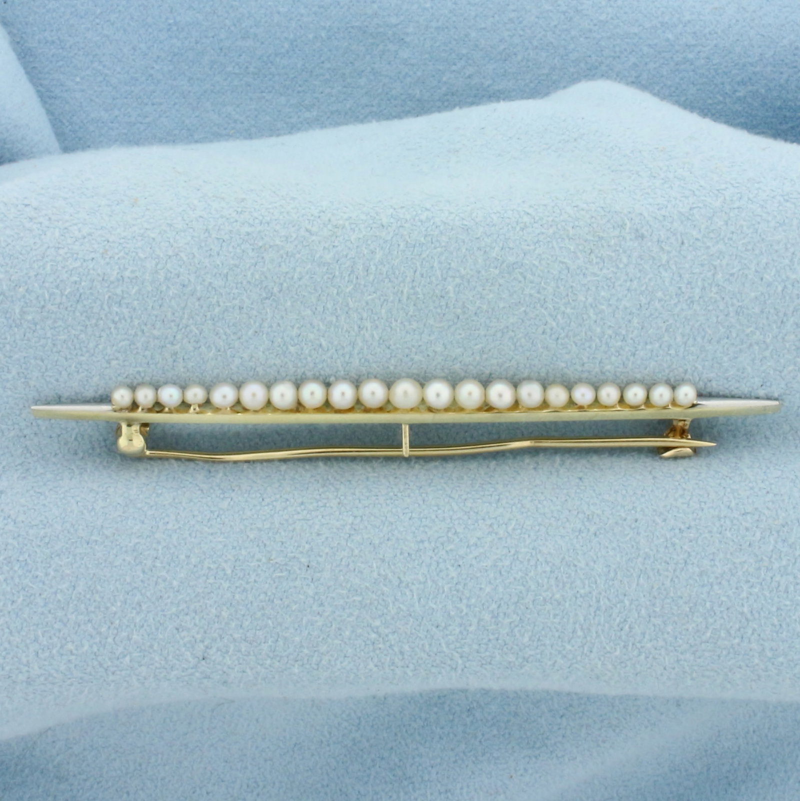 Vintage Seed Pearl Pin Brooch in 14k Yellow Gold: In 14k Yellow Gold with White Gold Accent. Contains twenty one 2 to 2.75mm seed pearls with high luster. 2 3/8 inch long. 1/8 inch wide. 2.8g.