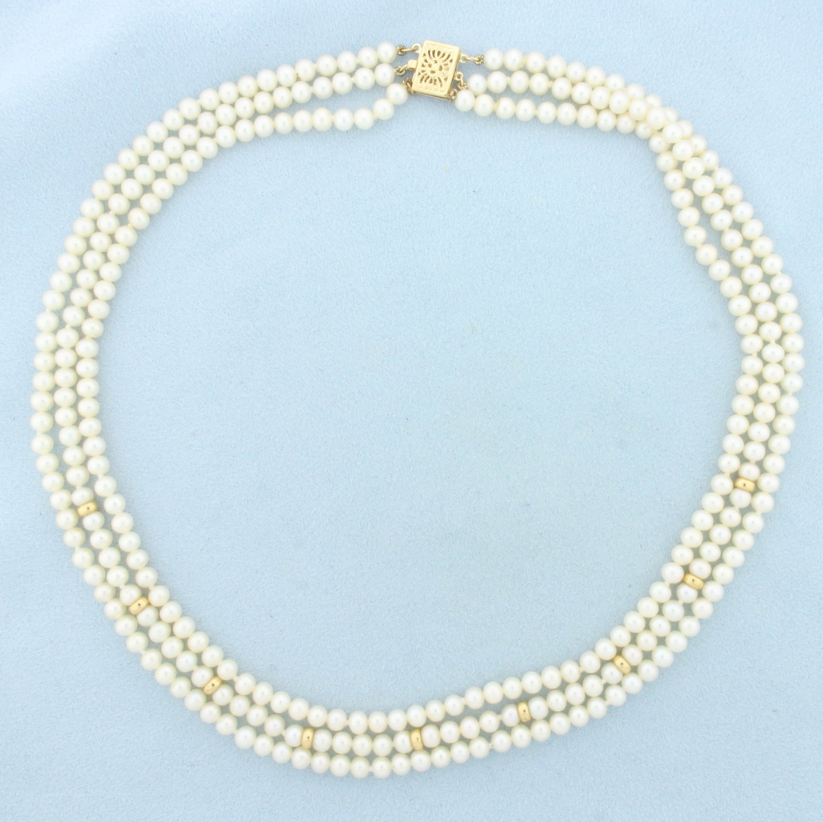 Triple Strand Pearl and Gold Bead Necklace in 14k Yellow Gold: In 14k Yellow Gold Clasp and Beads. Contains high quality 4.25-4.5mm pearls with high luster. 4.1mm gold beads. Shortest strand in 16 inches long. Hand knotted.