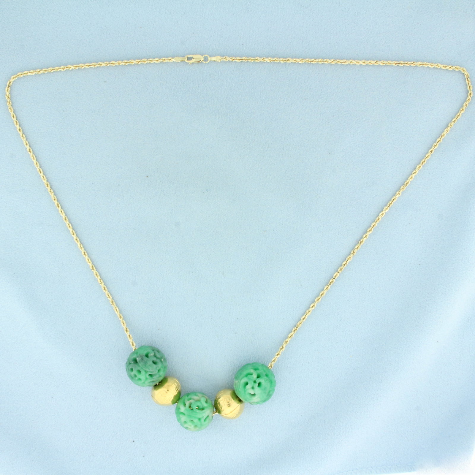 Carved Jade and Gold Bead Necklace in 14k Yellow Gold: In 14k Yellow Gold. Contains three high quality 16.3-17.3mm carved jade beads. Also contains two 13mm embossed gold beads. 22 inch long rope link chain. 1.7mm wide. Lobster clasp. 30.5g.