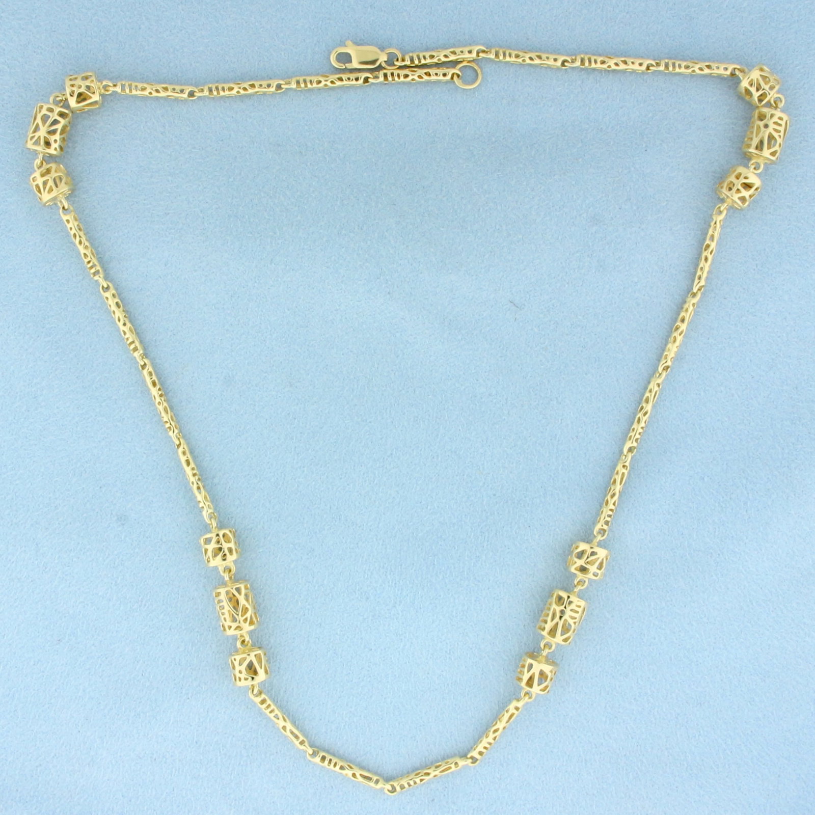 18 Inch Designer Cage Link Chain Necklace in 14k Yellow Gold: In 14k Yellow Gold. 18 inches long. 7mm wide at widest. Lobster clasp. 19.1g.