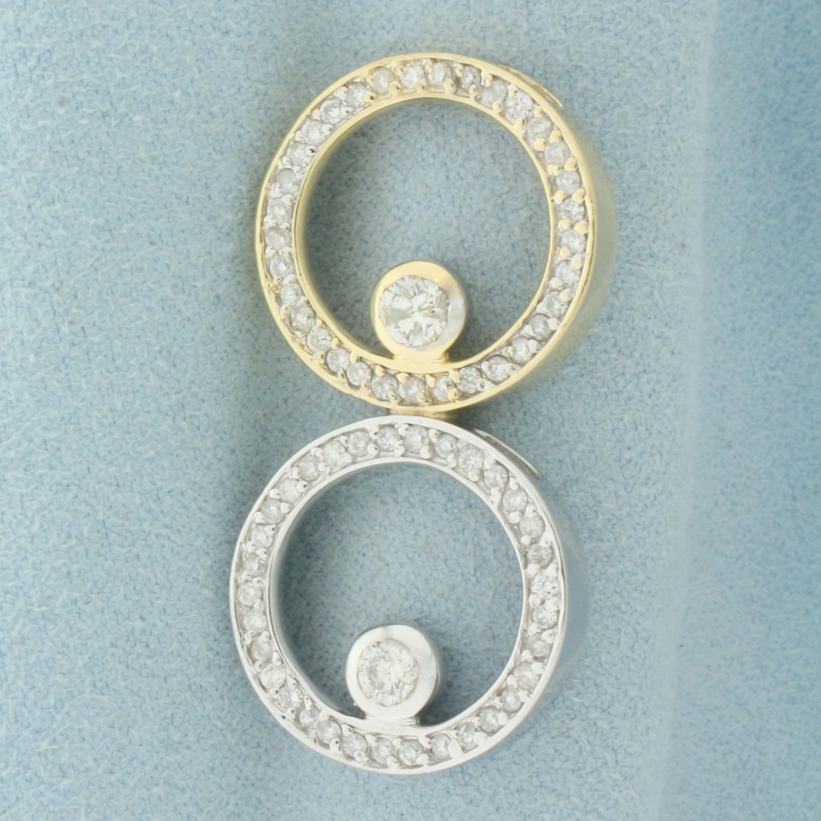 Diamond Two Tone Circle Pendant in 14k Yellow and White Gold: In 14k Yellow and White Gold. Contains two 1/5ct ct and sixty-six .01ct high quality diamonds, over 1ct TW, SI clarity/H color. 1 1/2 inch long. 3/4 inch wide. 8.4g.