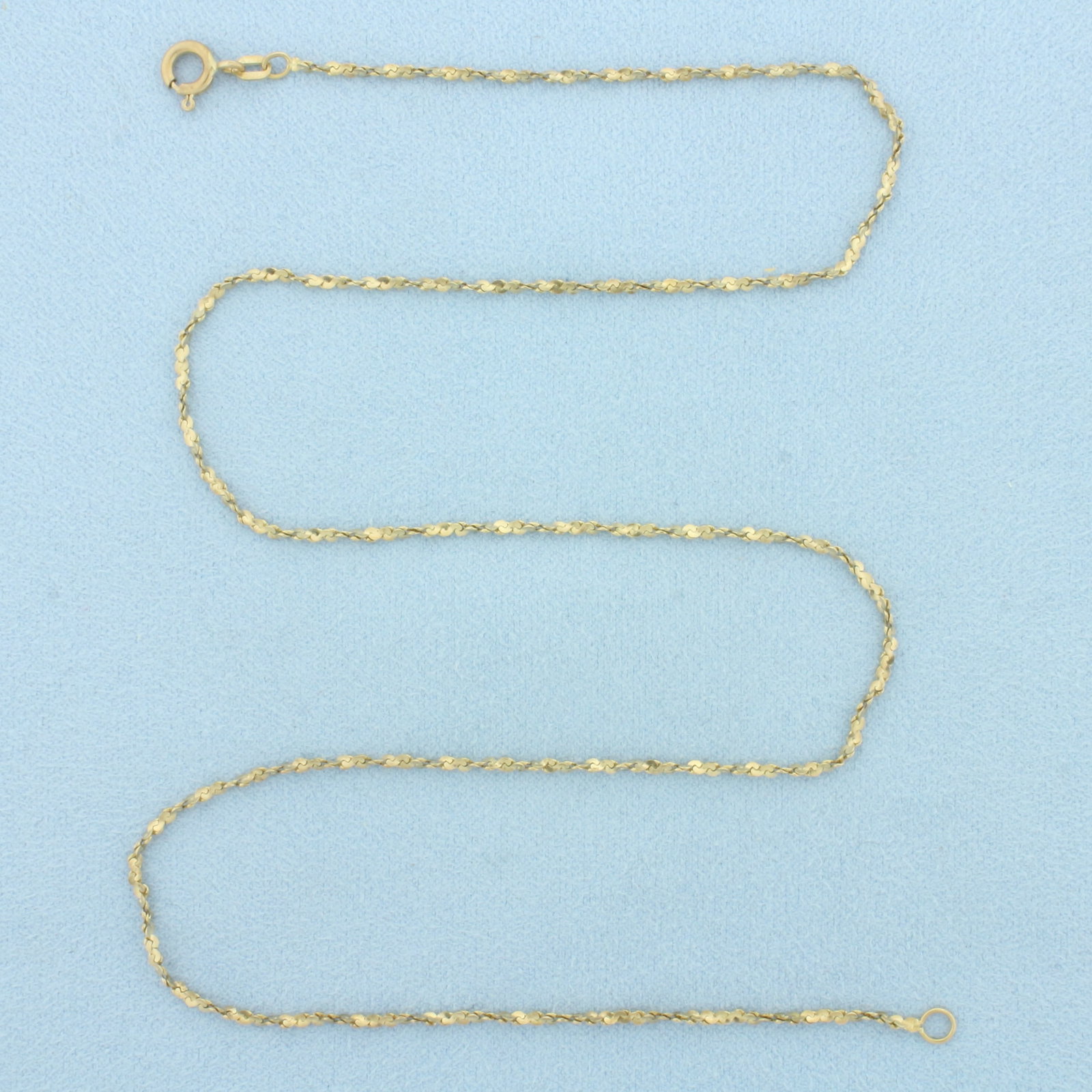 18 Inch Italian Twisting S-Link Chain Necklace in 14k Yellow Gold: In 14k Yellow Gold. 18 inches long. 1.4mm wide. Made in Italy. Spring clasp. 3.4g.