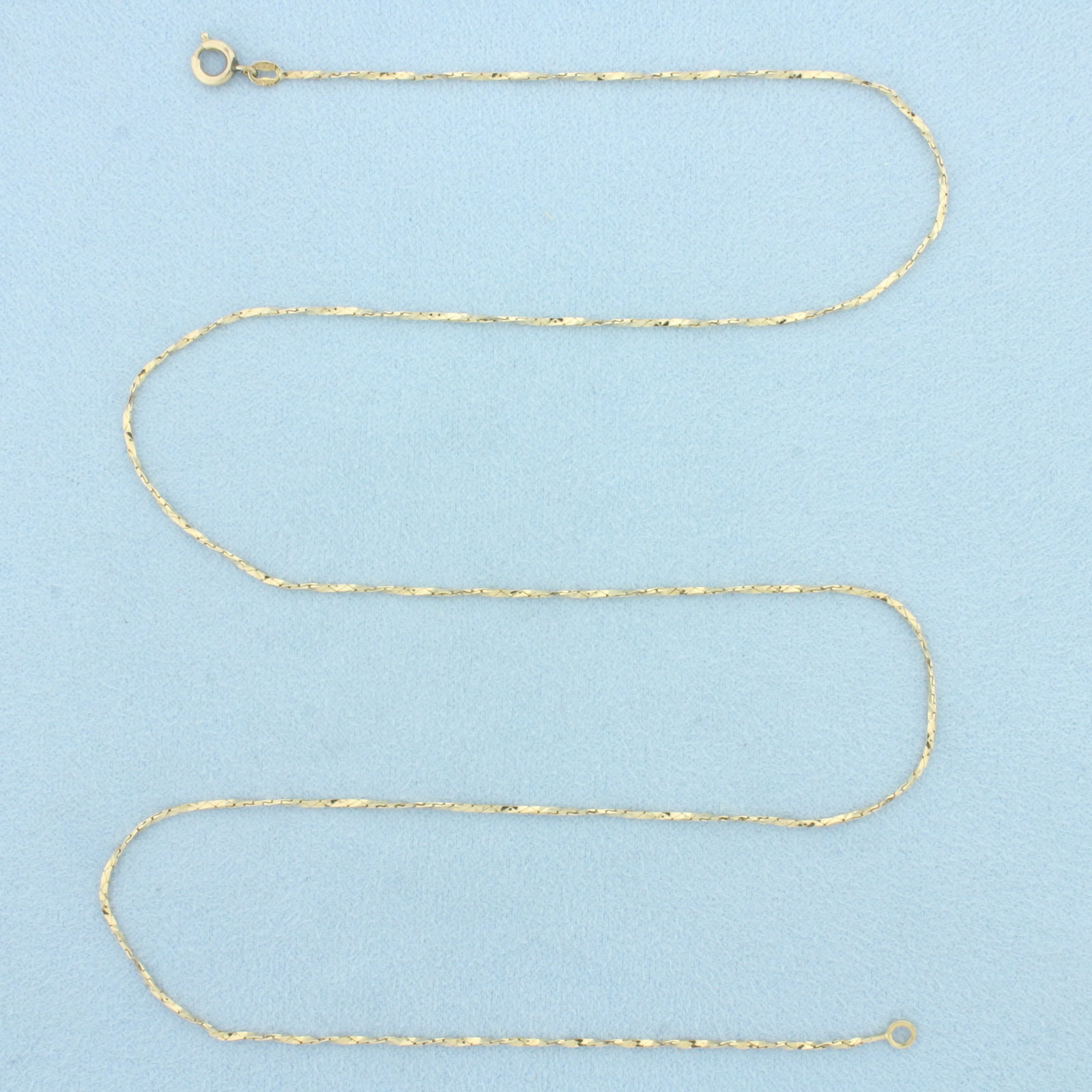 21 Inch Italian Twisting Cobra Link Chain Necklace in 14k Yellow Gold: In 14k Yellow Gold. 21 inches long. 0.9mm wide. Made in Italy. Spring clasp. 2.4g.