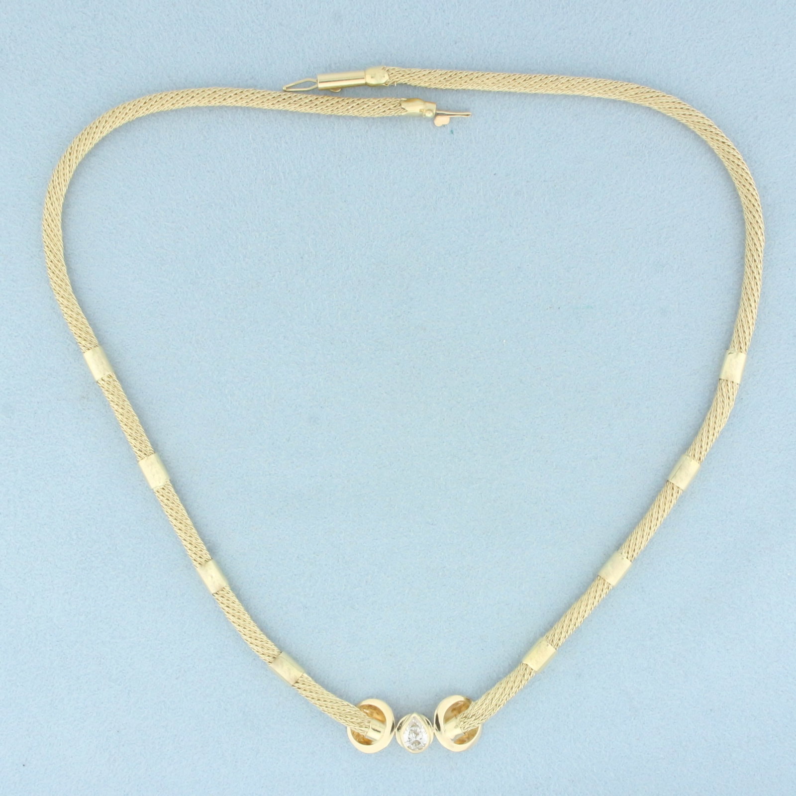 Pear Diamond Mesh Necklace in 14k Yellow Gold: In 14k Yellow Gold. Contains one high quality 1/2ct pear diamond, VS clarity/I color. 16 inches long. 4mm wide. Barrel clasp with safety latch. 15.4g.
