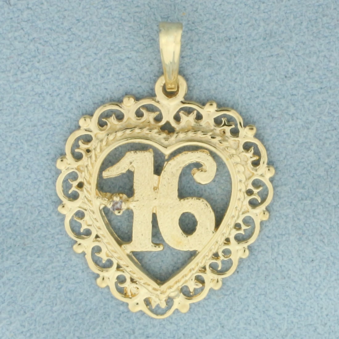 Diamond Sweet 16 Pendant in 14k Yellow Gold: In 14k Yellow Gold. Contains one .01ct high quality diamond. 1 1/4 inch long including bail. 7/8 inch wide. 3.3g.
