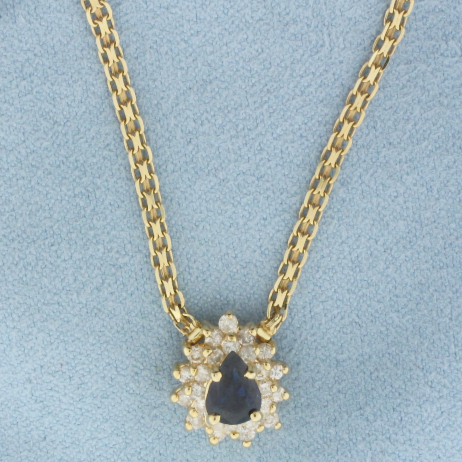 Sapphire and Diamond Necklace in 14k Yellow Gold: In 14k Yellow Gold. Contains one 7mm high quality natural Sapphire gemstone, approximately 3/4ct, with intense color and excellent clarity. Also contains twenty-five .02ct high quality diamonds, SI cl