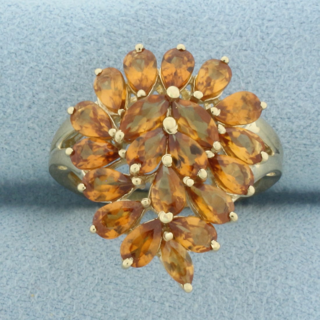 Golden Citrine Statement Ring in 10k Yellow Gold: In 10k Yellow Gold. Contains three 6x3mm marquise cut and seventeen 5x3mm pear cut high quality natural Citrine gemstones, approximately 4ct TW, with rich golden color and excellent clarity. 23mm wide
