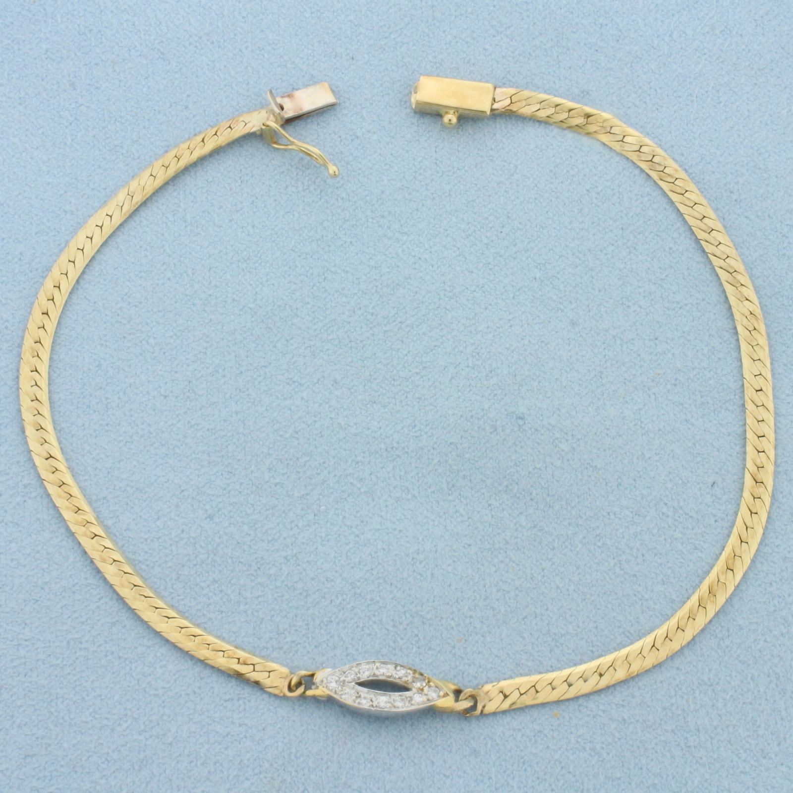 Italian Diamond Evil Eye Bracelet in 14k Yellow Gold: In 14k Yellow Gold. Contains twelve high quality 1/2pt diamonds. Center is 5.8mm wide. 3mm wide herringbone link. Slide clasp with safety latch. 5.5g.