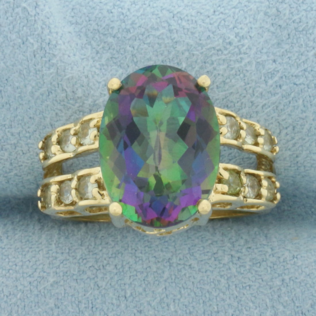 Mystic Topaz and Green Topaz Ring in 10K Yellow Gold: In 10k yellow gold. Contains one 14mm high quality Mystic Topaz gemstone with intense color and excellent clarity. Also contains twelve 2mm high quality natural Green Topaz gemstones of similar high q