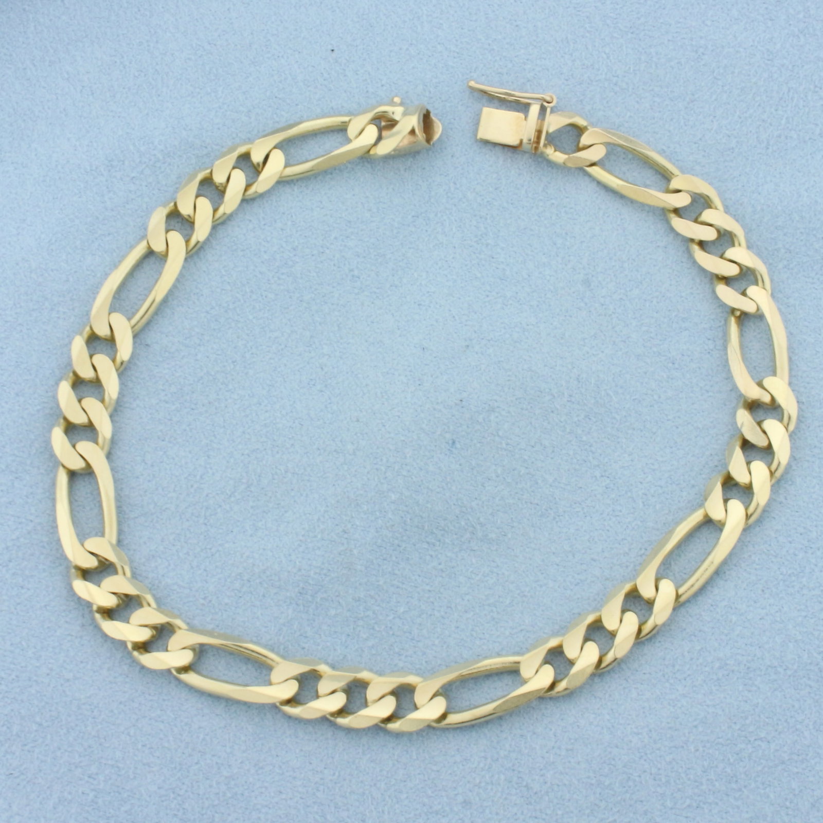 Mens Figaro Link Bracelet in 14k Yellow Gold: In 14k yellow gold. 8.5 inches long and 6.6mm wide. Solid links. Slide clasp with safety latch. 16.5g.