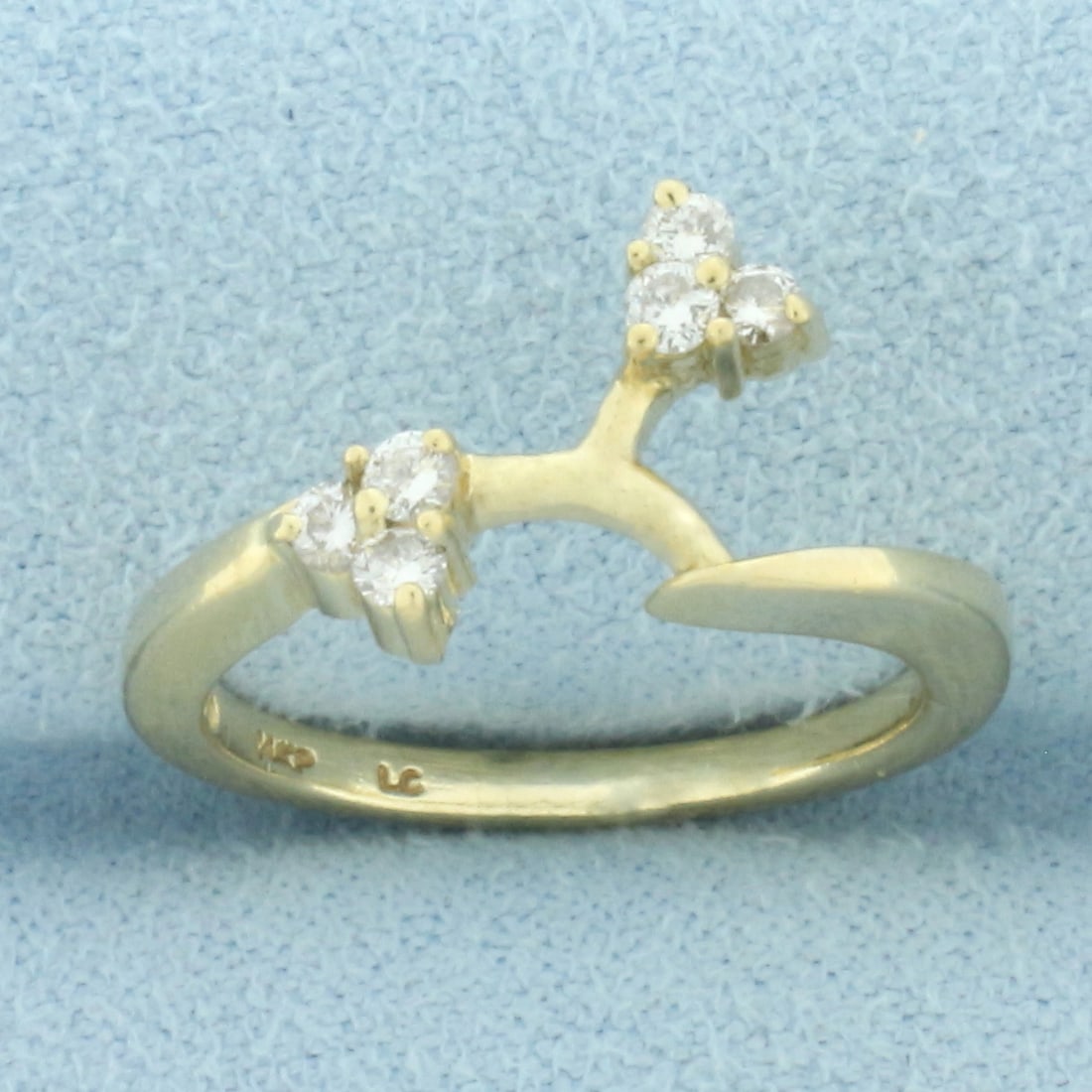 Diamond Ring Enhancer Jacket in 14k Yellow Gold: In 14k yellow gold. Contains six high quality .03ct diamonds, VS clarity/G color. 10mm wide at widest point. Size: 4. 2.3g.