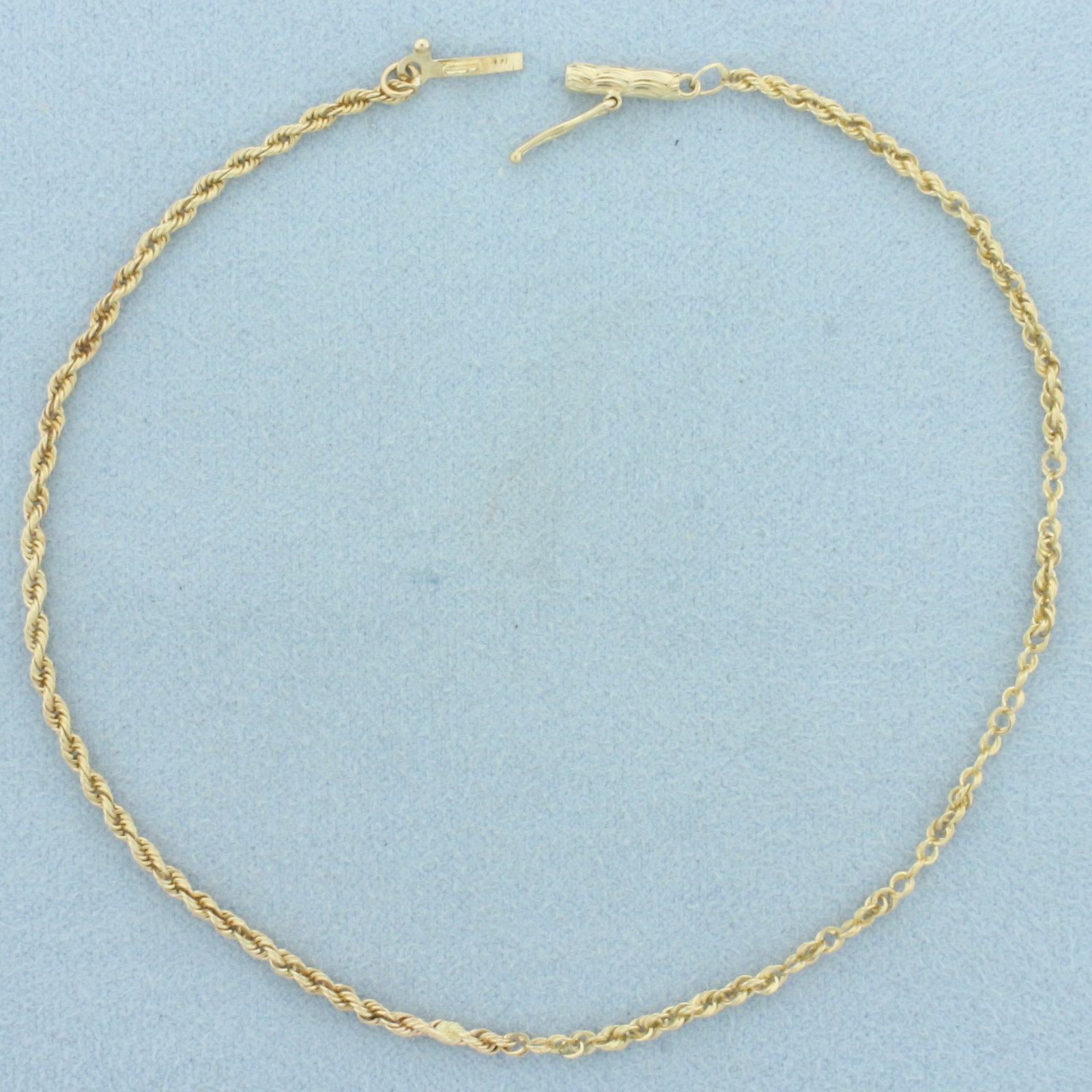 Rope Link Anklet in 14k Yellow Gold: In 14k Yellow Gold. 9 1/4 inches long. 1.8mm wide. Some repairs as shown, not noticeable. Barrel clasp with safety latch. 2.6g