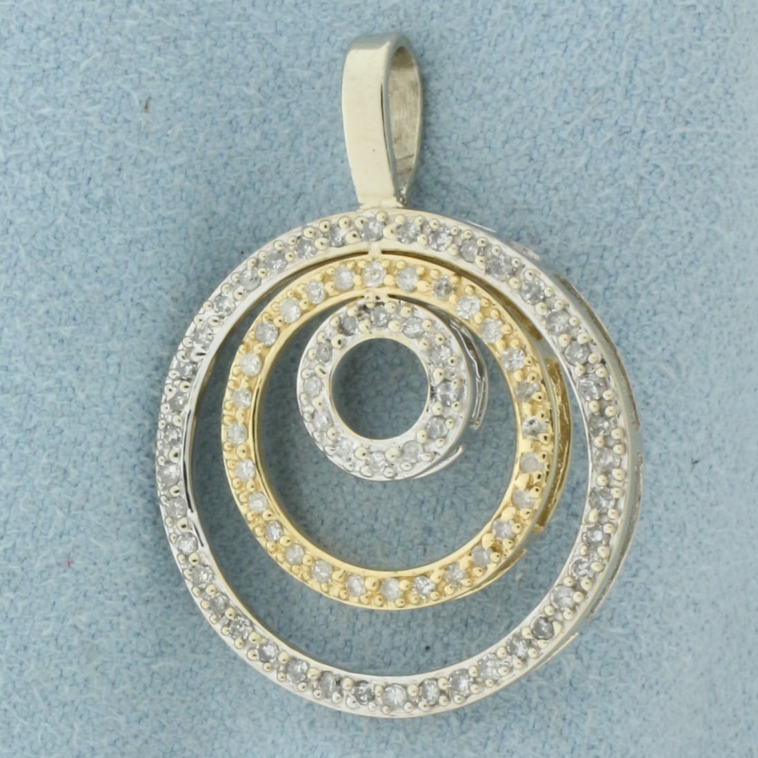 Circles Dimond Pendant in 14k White and Yellow Gold: In 14k White and Yellow Gold. Contains eighty-two high quality 1/2pt diamonds. 1 1/8 inch long. 7/8 inch wide. 3.7g.