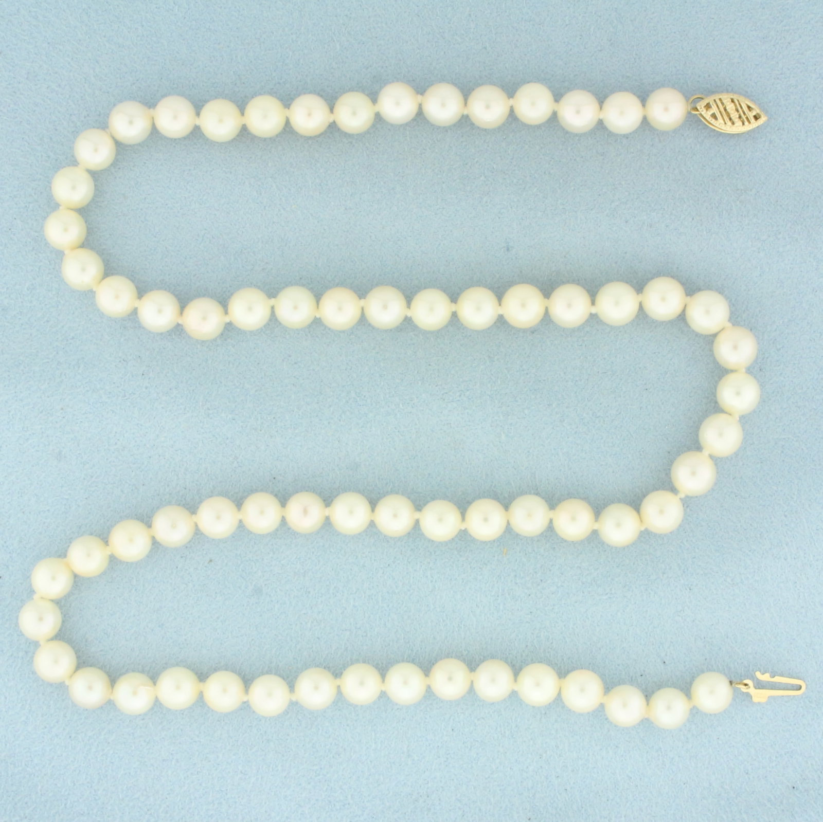 Akoya Pearl Strand Necklace in 14k Yellow Gold: In 14k Yellow Gold. Contains 6mm high quality Cultured Akoya Pearl gemstones with high luster. 18 inches long. Hand knotted. Decorative locking filigree clasp. 22.3g