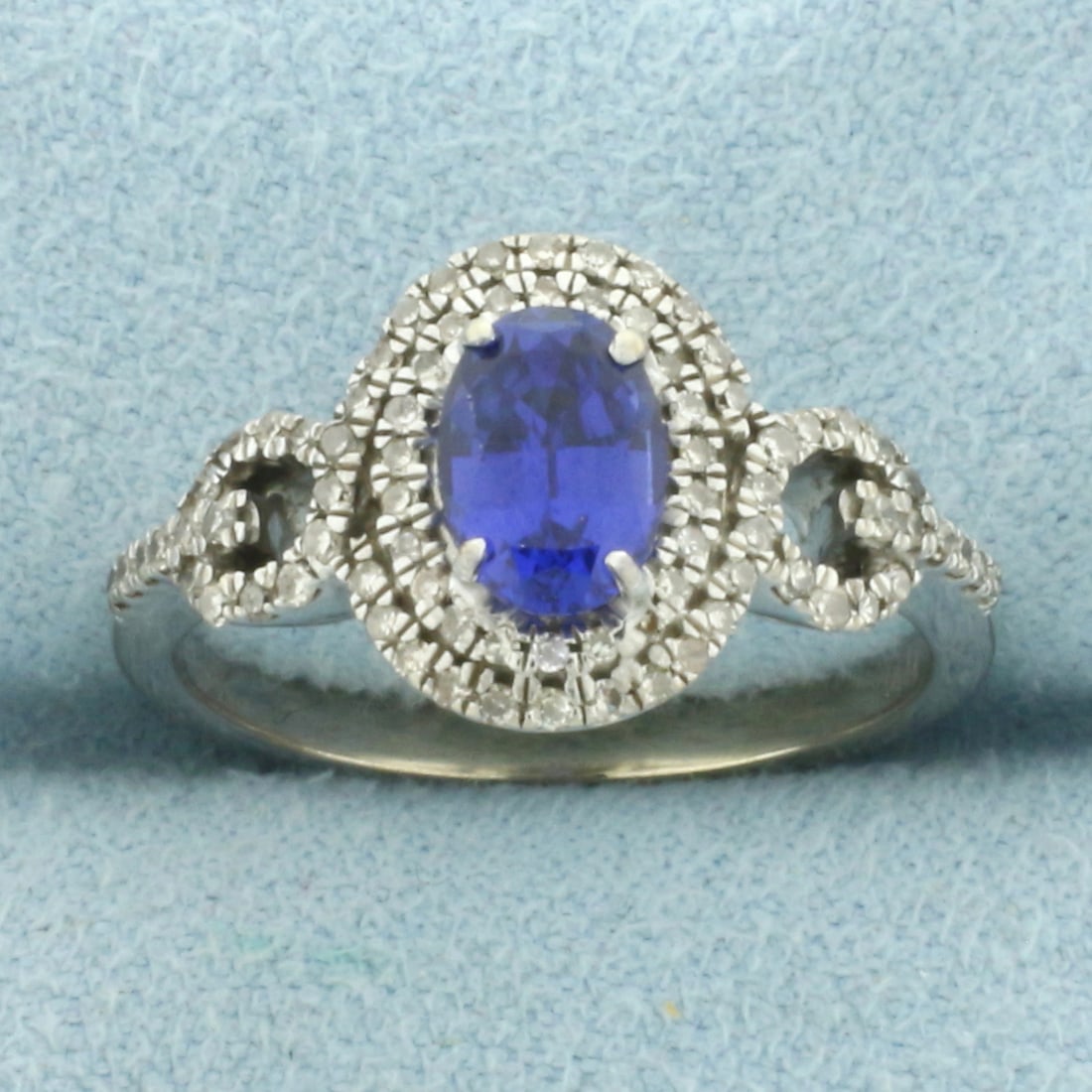 Lab Sapphire and Diamond Double Halo Ring in 10k White Gold: In 10k White Gold. Contains one 7x5mm high quality oval Lab Sapphire gemstone, approximately 1ct, with intense color and excellent clarity. Surrounded by approximately 1ct TW of 1/2ct high quality dia