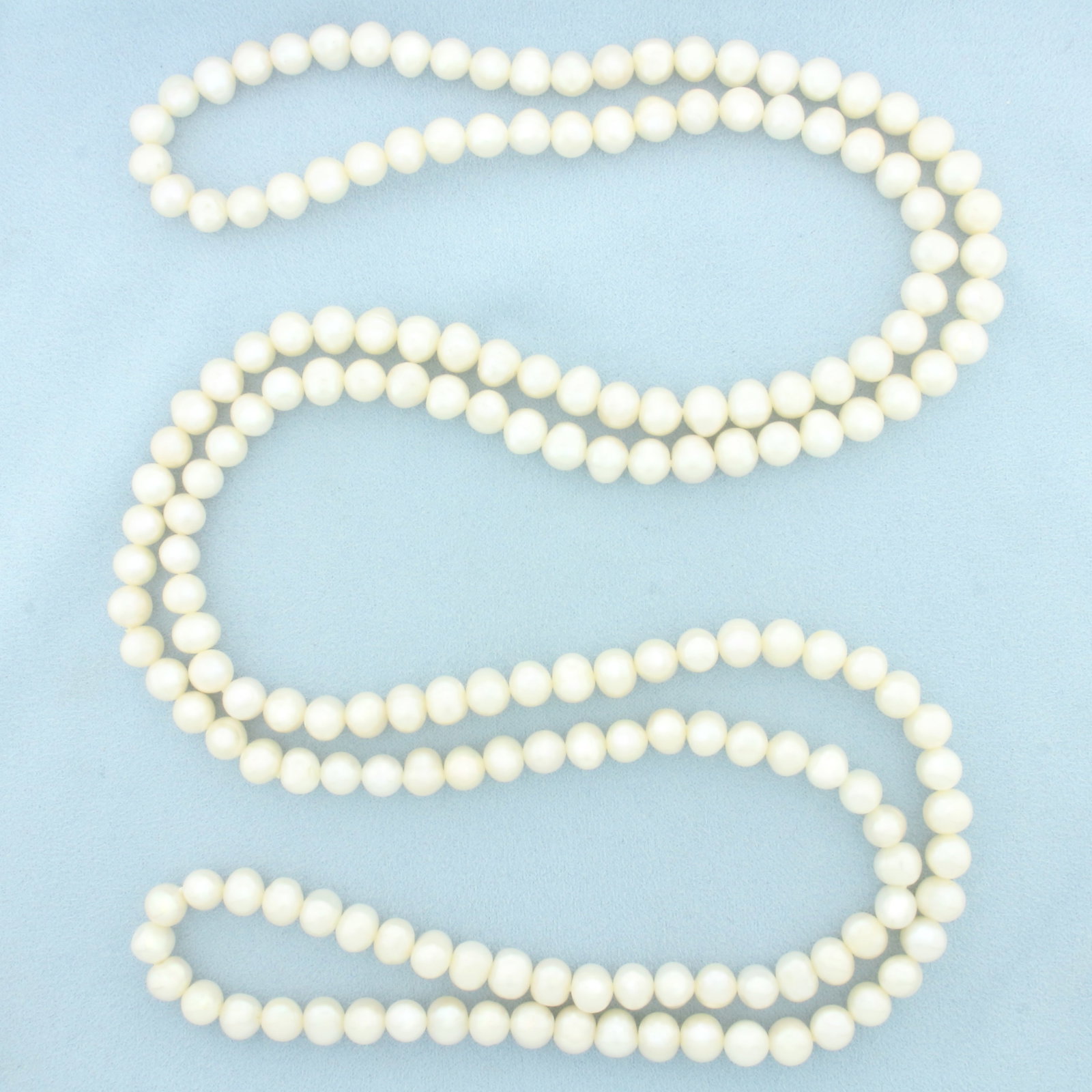 Long Cultured Pearl Strand Necklace: Contains 8.5-9mm high quality Cultured Pearls with high luster. 54 inches long.