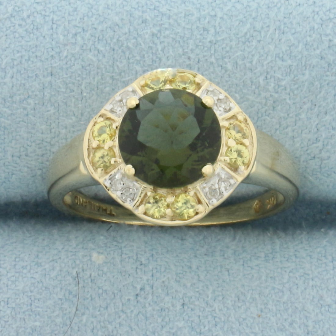 Green Tourmaline, Yellow Sapphire, and Diamond Ring in 10k Yellow Gold: In 10k Yellow Gold. Contains one 8mm high quality natural Green Tourmaline gemstone, approximately 2cts, with intense color and excellent clarity. Also contains eight high quality 1/2pt diamonds and e