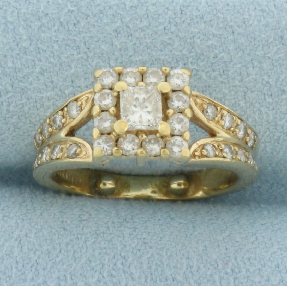 Princess Cut Diamond Halo Engagement Ring in 14k Yellow Gold: In 14k Yellow Gold. Contains one high quality 1/3ct princess cut diamond, SI clarity/H color, eye clean, great cut for added brilliance. Also contains 28 round diamonds, 2/3ct TW, of similar high