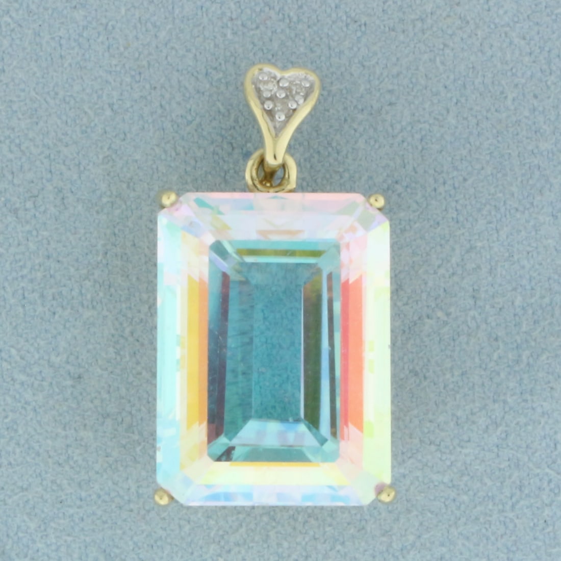 Large Mystic Topaz and Pave Diamond Heart Pendant in 14k Yellow Gold: In 14k Yellow Gold. Contains one 20x15mm high quality Mystic Topaz gemstone with intense color and excellent clarity. Also contains three .01ct high quality diamonds, SI clarity/H color. 1 1/8 inches