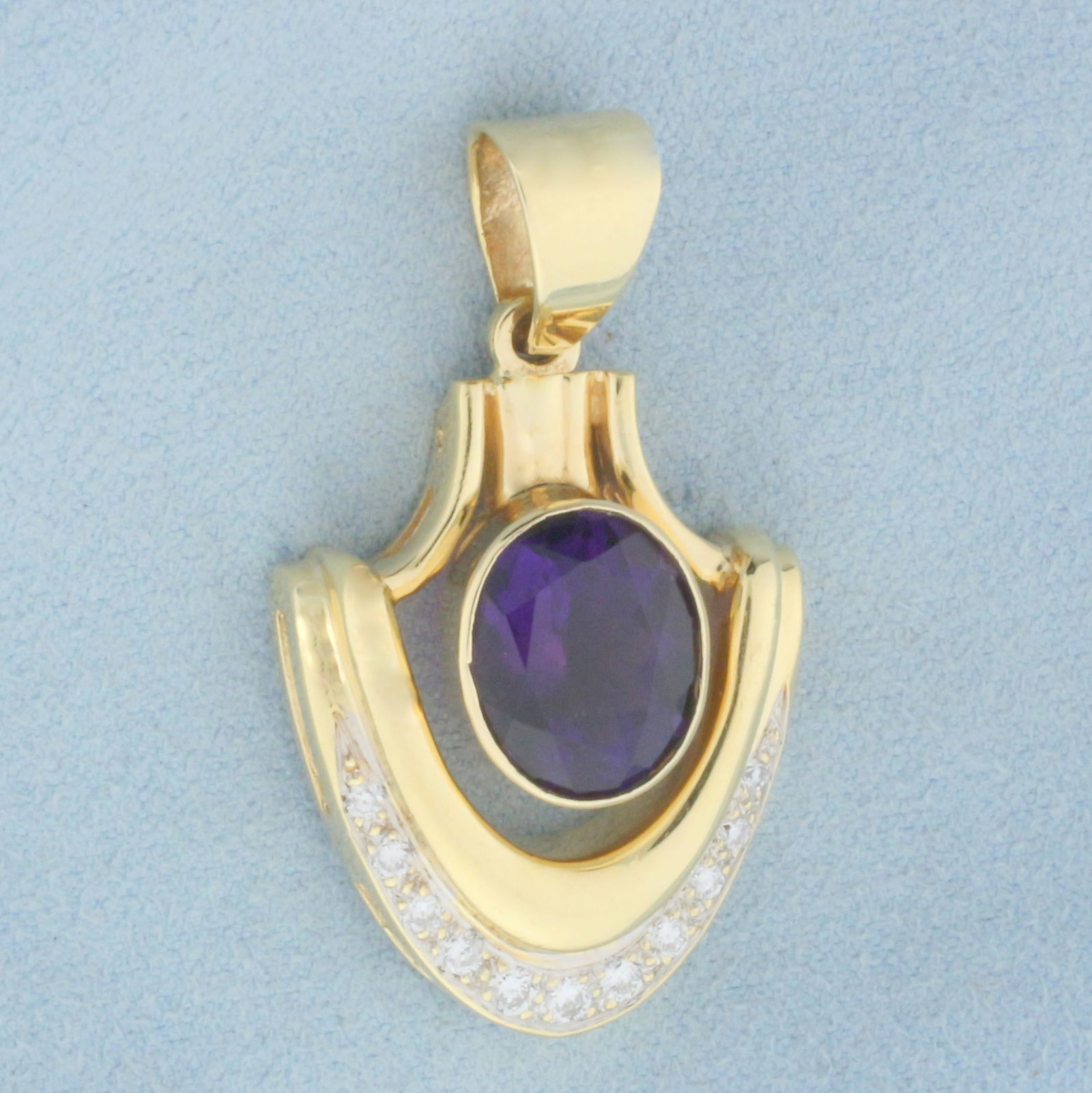 Vintage Amethyst and Diamond Pendant in 14k Yellow Gold: Iin 14k Yellow Gold. Contains one 12x10mm high quality natural Amethyst gemstone, approximately 6cts, with vibrant color and excellent clarity. Also contains eleven high quality diamonds, 1/4ct TW, VS