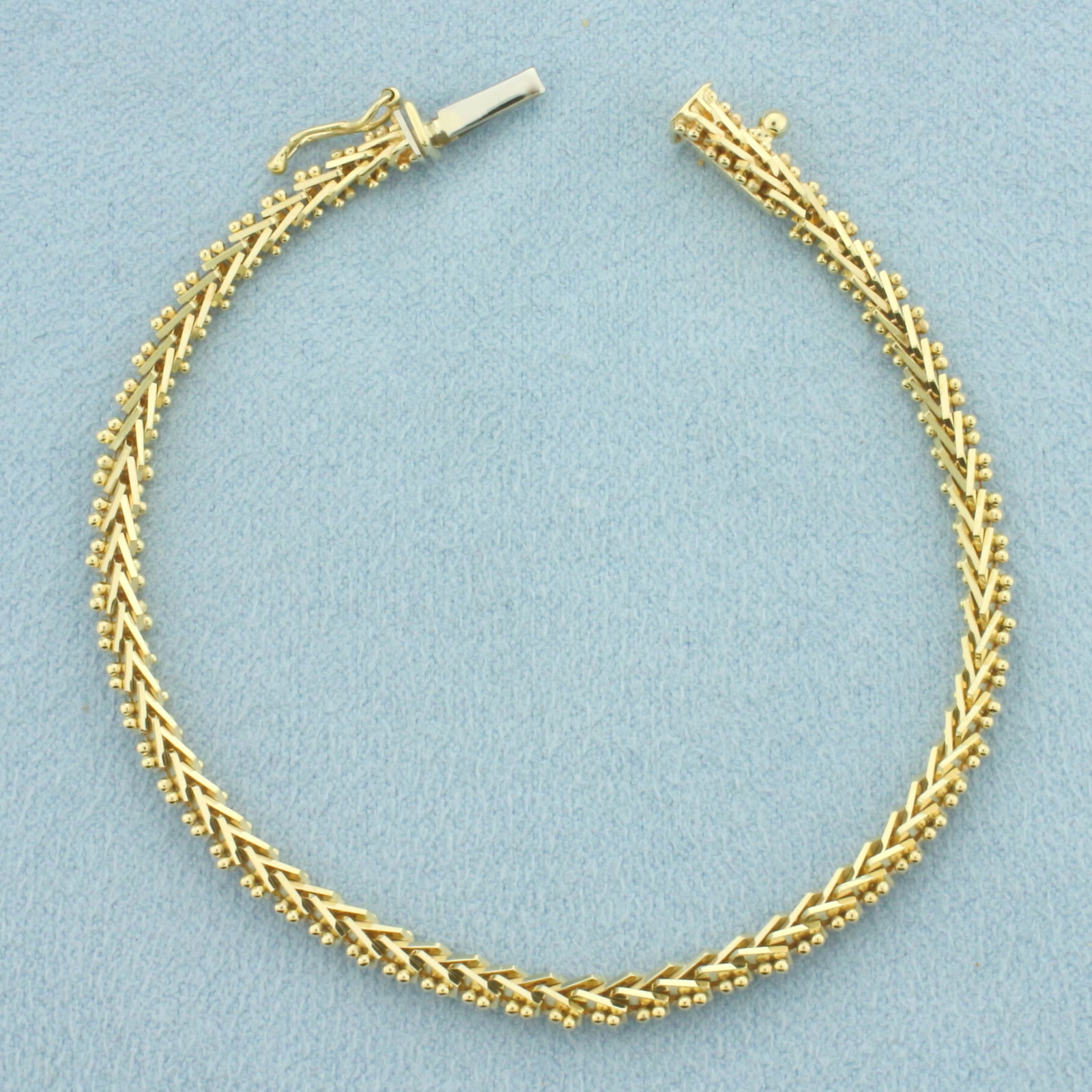 Geneva Link Bracelet in 14k Yellow Gold: In 14k Yellow Gold. 6 3/8 inches long. 3.6mm wide. Slide clasp with safety latch. 7.5g.