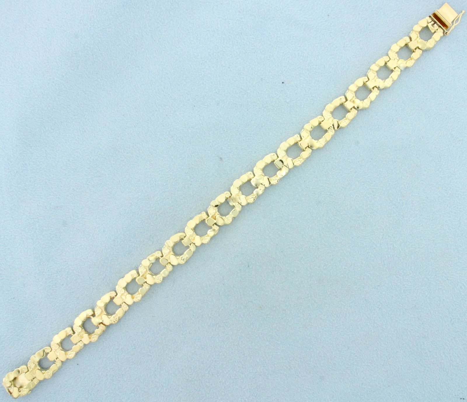 Nugget Horseshoe Link Bracelet in 14K Yellow Gold: In 14K Yellow Gold. 8 inches long, 10.3mm wide. Safety clasp. 32.9g.