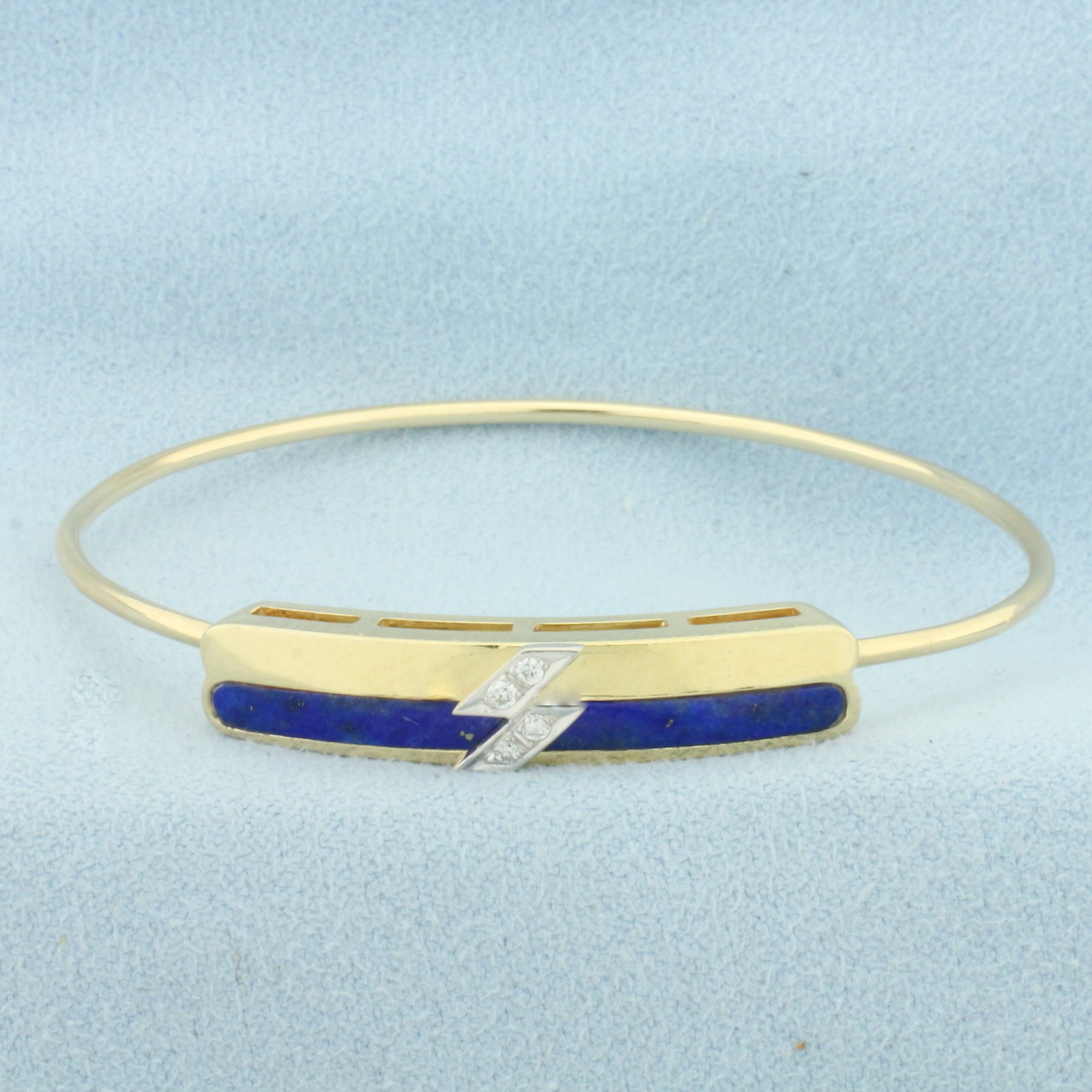 Lapis Lazuli and Diamond Hinged Bangle Bracelet in 14k Yellow Gold: In 14k Yellow Gold. 1.25 inch polished lapis lazuli. Also contains four high quality 1/2pt diamonds. Interior dimensions: 2 1/8 inches by 1 3/4 inch. 6.6mm at widest. Hinged locking closure. 7.9g.